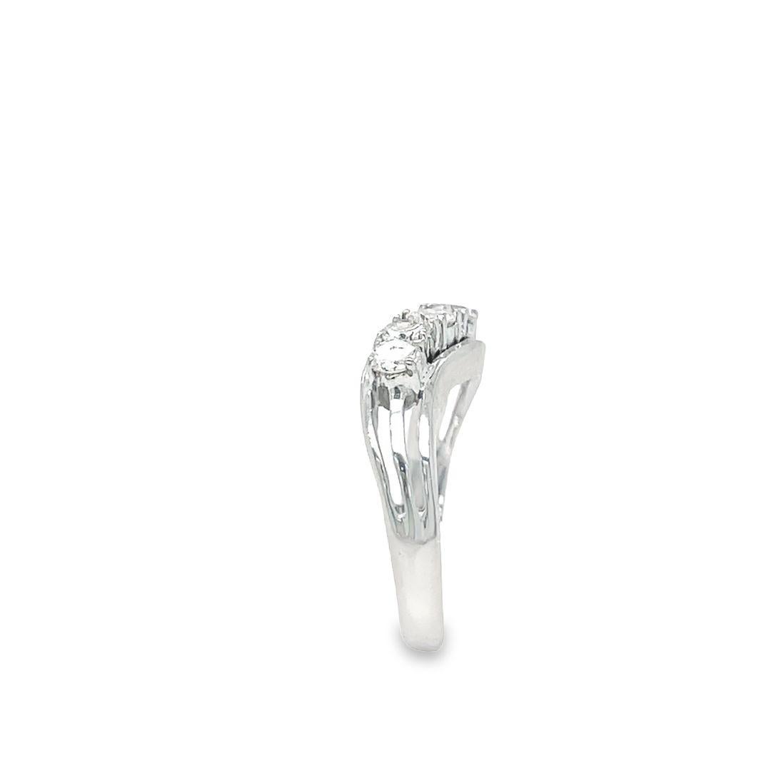 This vintage 14k white gold diamond ring is a true beauty, with a curved design that's both elegant and modern. The ring features five full-cut diamonds, each set in four prongs and totaling 0.50 carat with G-H color and SI1 clarity. With a weight