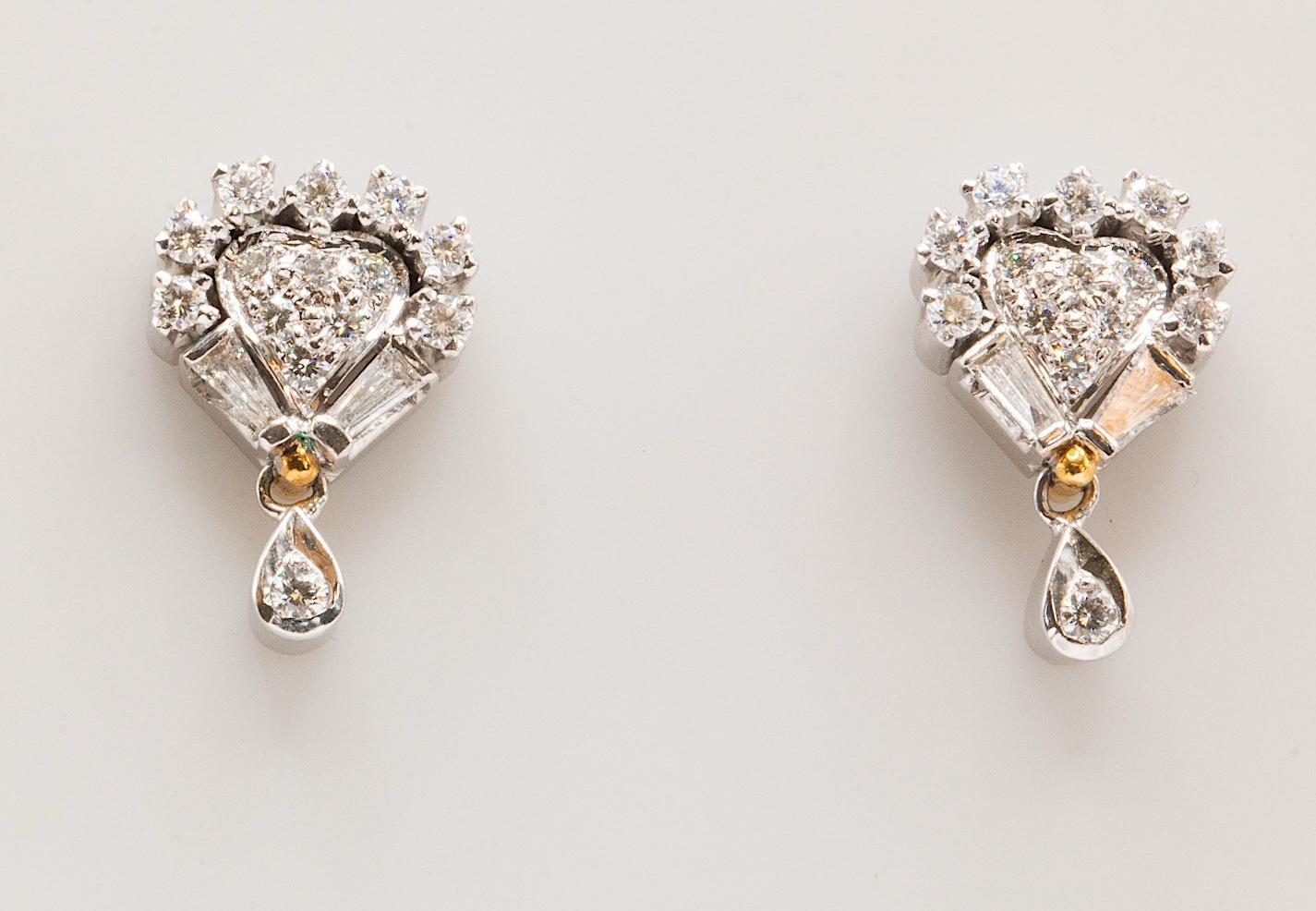Vintage 14K White Gold Diamond Heart-Shaped Dangle Earrings

These exquisite vintage earrings, crafted in lustrous 14K white gold, feature an elegant heart-shaped dangle design adorned with a captivating blend of natural round brilliant and baguette