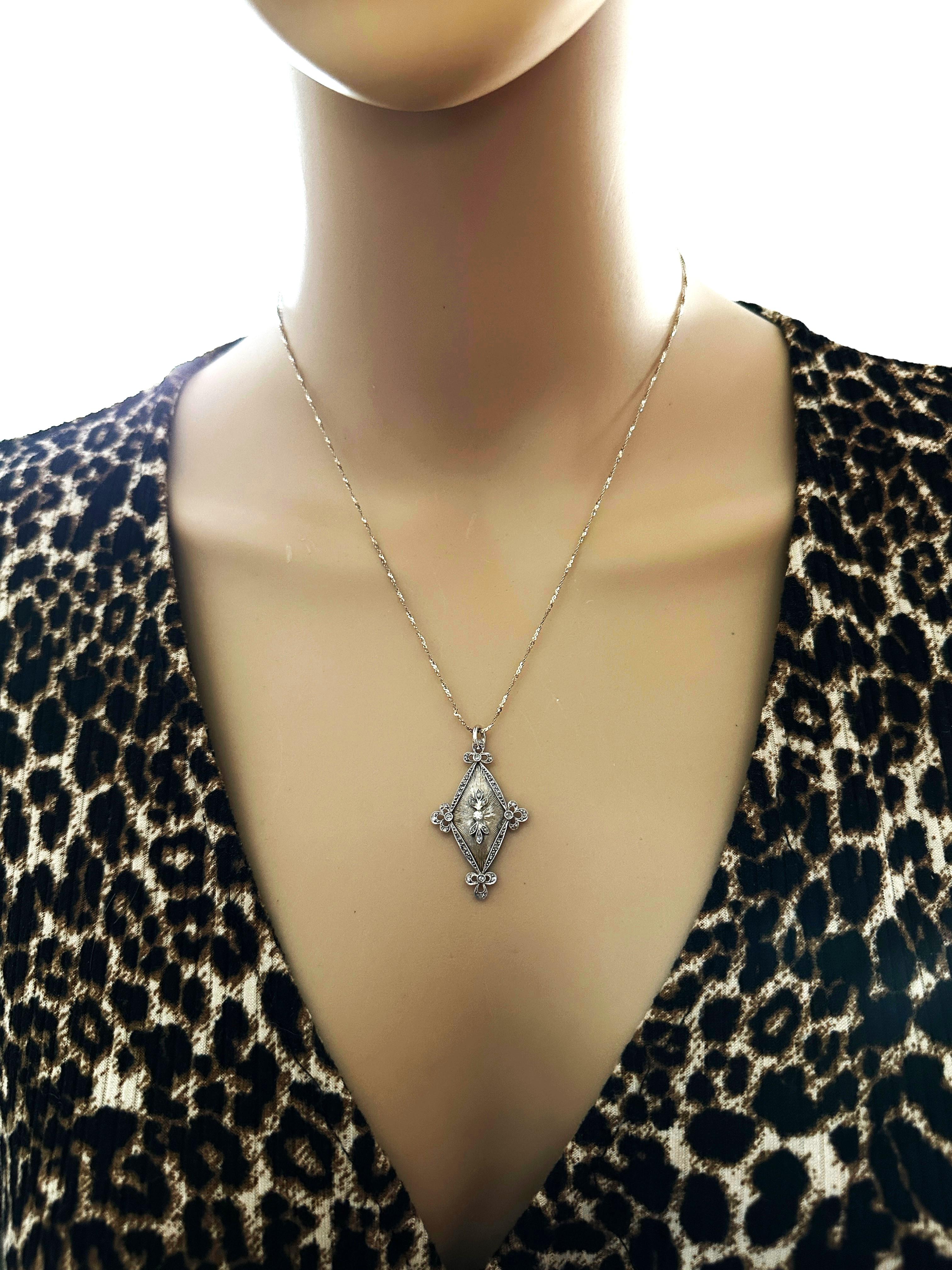 What a gorgeous necklace!!  The border of the pendant is lined brilliant cut stones.  I know that the stones on top, bottom and in the middle test as diamonds.  The top stone is a mine cut diamond and the stones on the 4 corners are rose cut