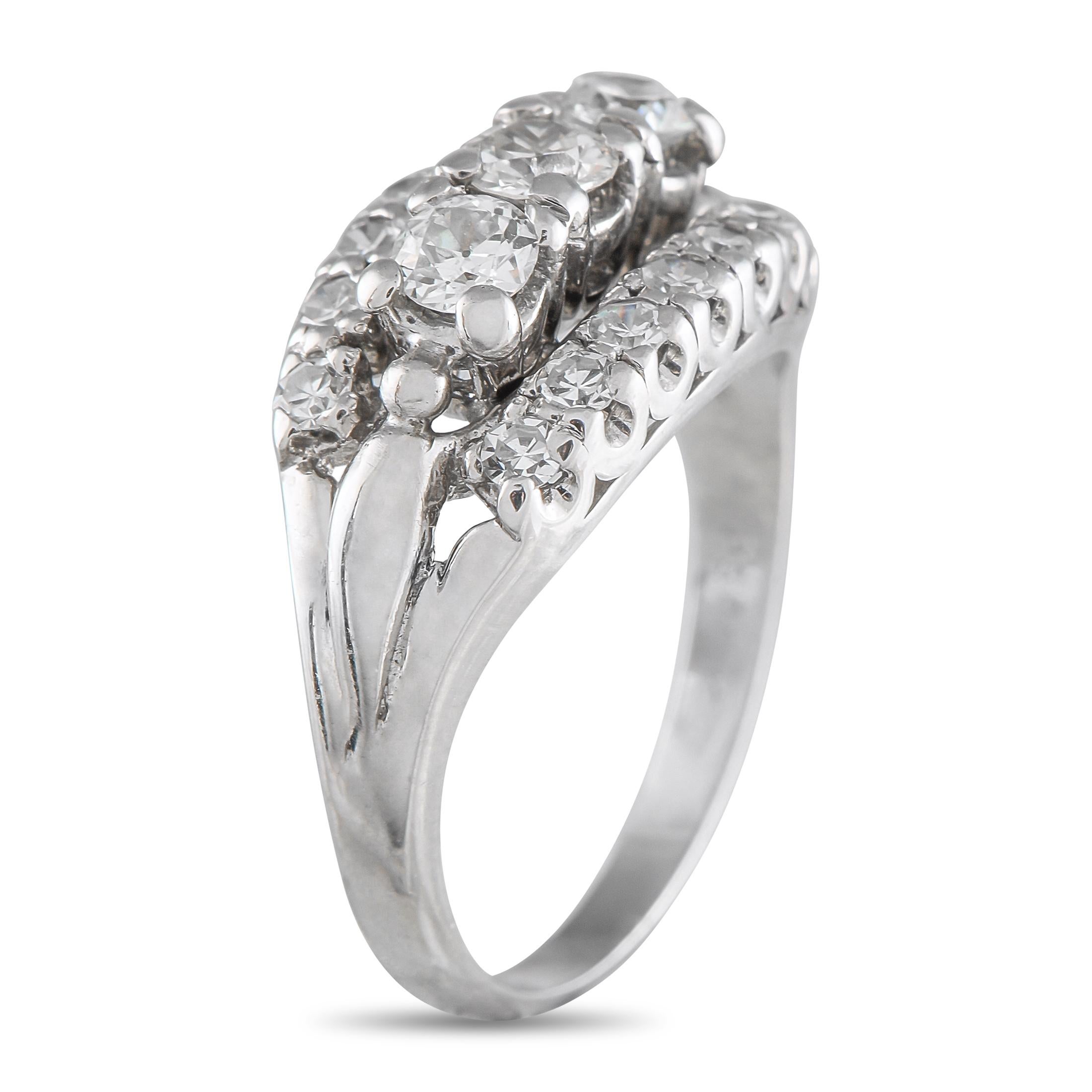 This vintage ring features a timeless design that will never go out of style. At the center of the 14K White Gold setting, three rows of Diamonds allow it to effortlessly catch the light every time its worn. A 2mm wide band and an 8mm top height