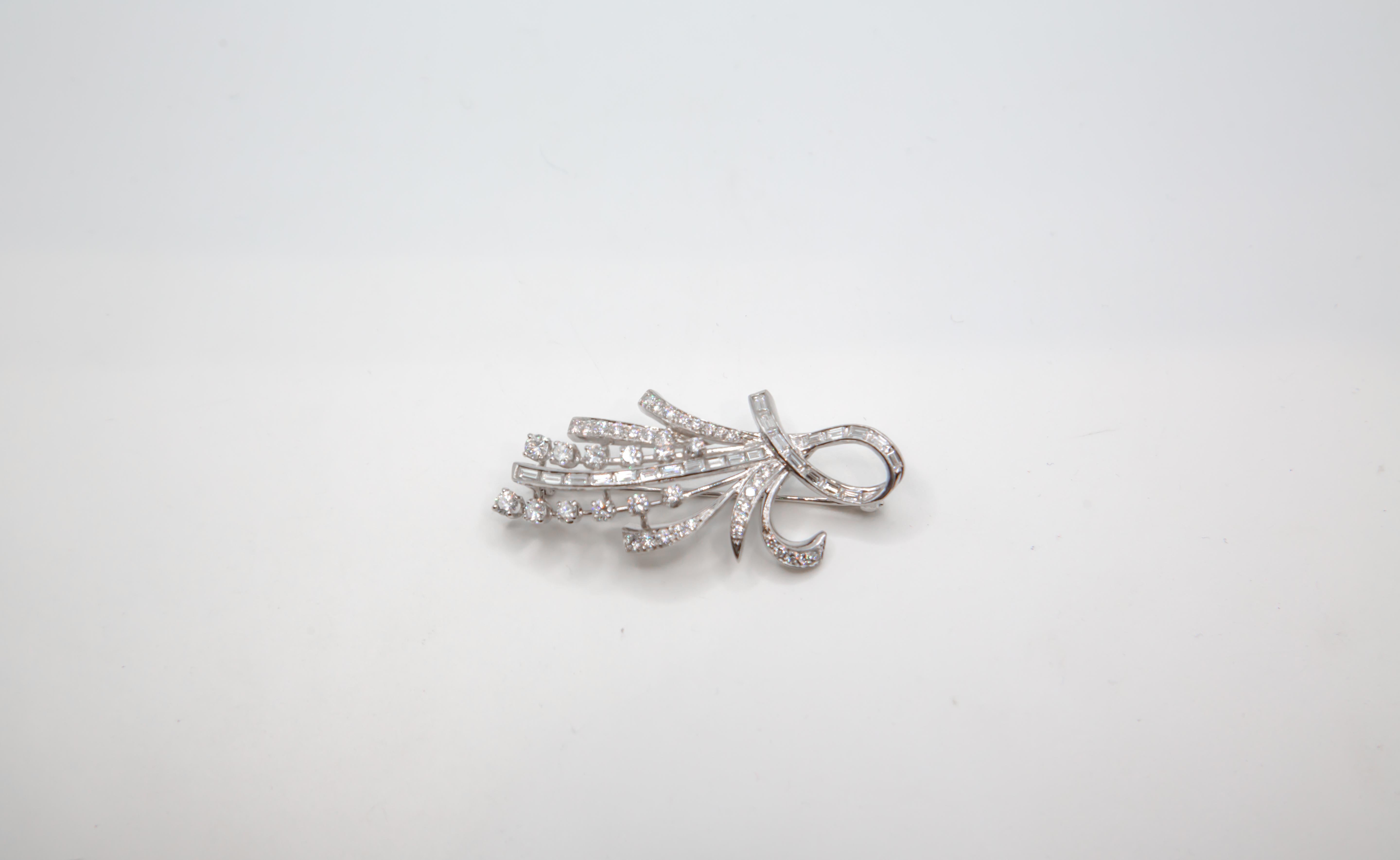 An exquisite vintage 14K white gold brooch designed in an elegant spray or floral bouquet motif, adorned with a dazzling arrangement of natural diamonds. This piece evokes the refined glamour of mid-century fine jewelry, where organic forms and