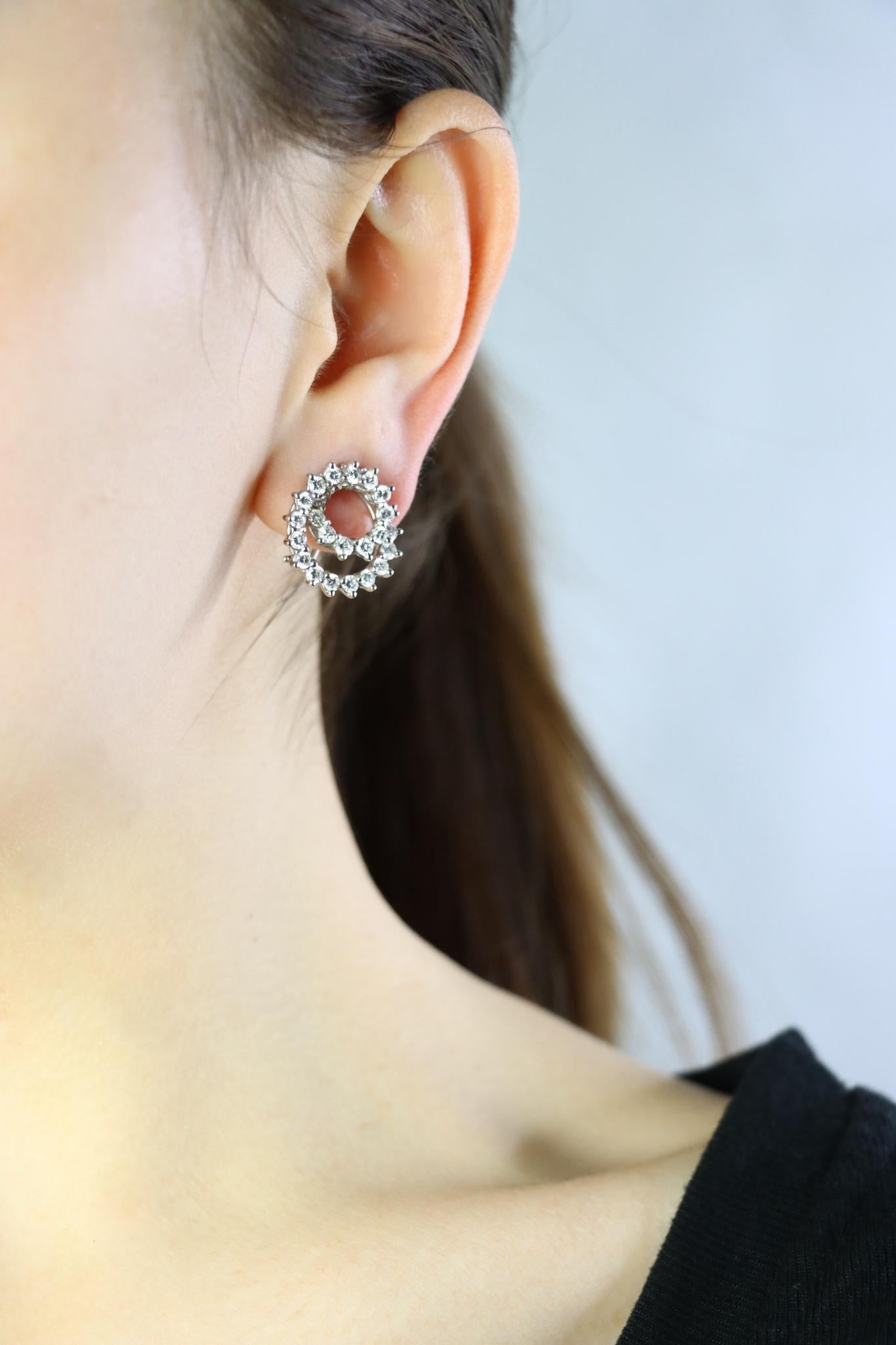 Vintage 14K White Gold Diamond Swirl Earrings

Marked:
14K

Approximate Dimensions:
2 cm (Diameter) 
Approx. 2.8 carats (Diamond)
7.8 grams in weight.

** All dimensions listed above are approximations based on our measurements and findings -