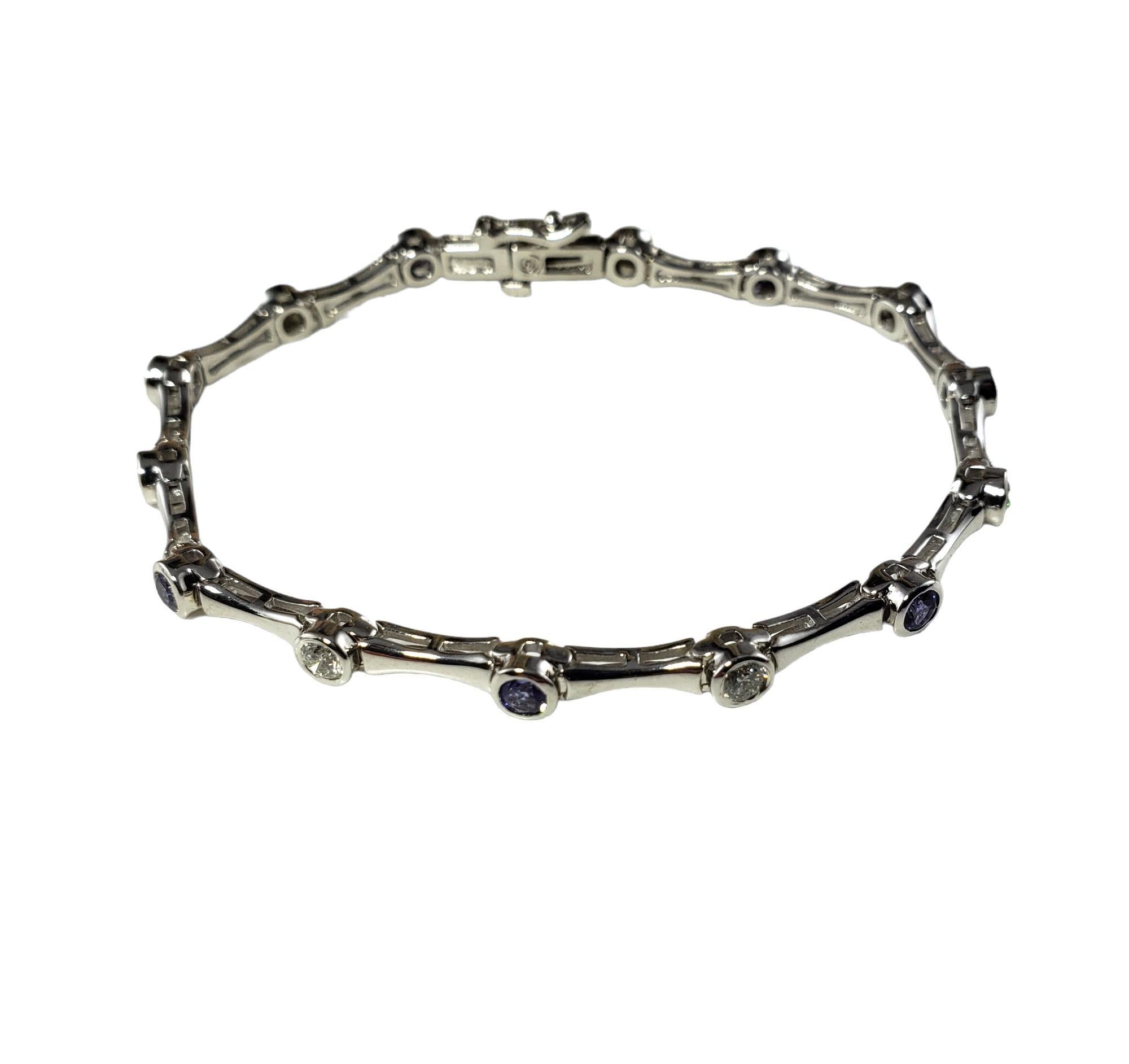 Vintage 14 Karat White Gold Diamond and Tanzanite Bracelet-

This lovely bracelet features seven round brilliant cut diamonds and seven round tanzanite stones set in classic 14K white gold.  Width:  4 mm.

Total tanzanite weight:  1.05 ct.

Total
