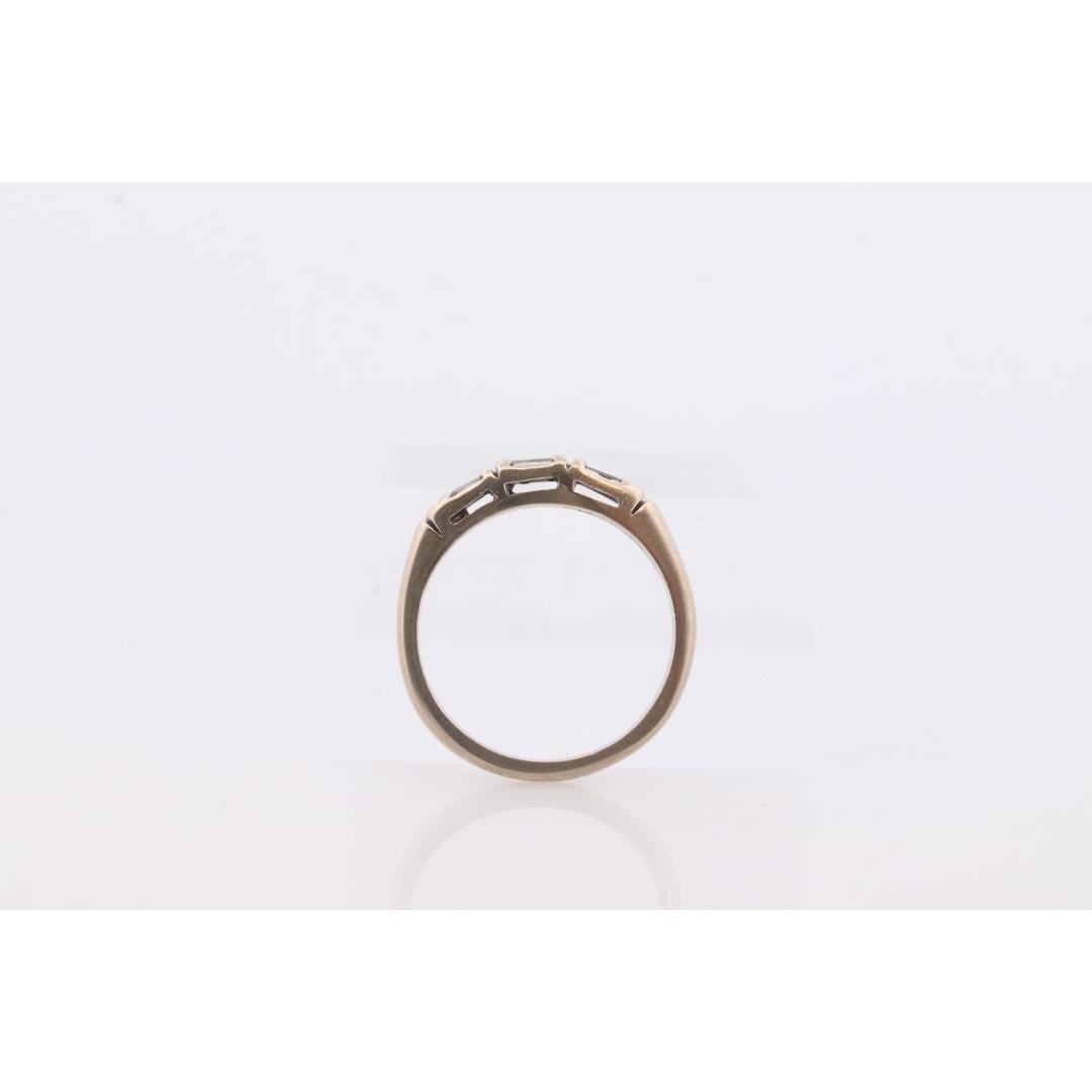 Vintage from the 1950s
Size: 6 US
Materials: Gold, Stone
Gemstone: Diamond
Gem Color: Colorless

Style: Art Deco

When Minimalism, Vintage, and Contemporary all meet in one band.

Beautiful Baguette Diamonds channel set into a band.

14k White