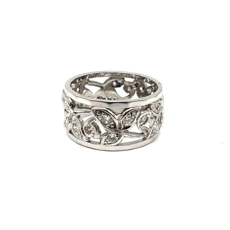 This vintage ring sparkles with 14k white gold and brilliant cut diamonds, placed beautifully within undulating leaves and a concentric foliate design. The leaves are reticulated, each of the details carefully cut out of the white gold in an elegant