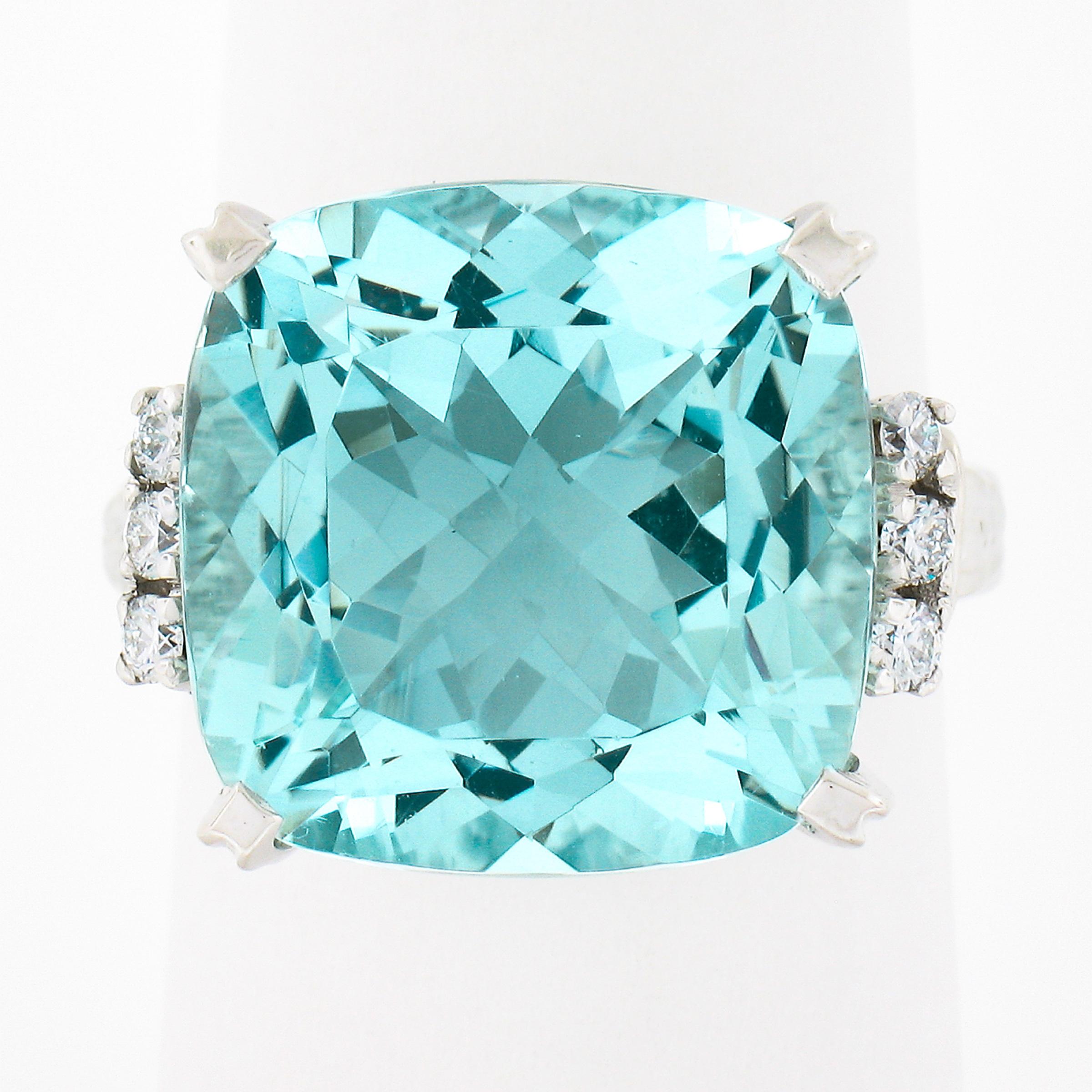 Up for sale we have an absolutely stunning, GIA certified, aquamarine and diamond cocktail ring. The very fine quality aquamarine is a large square cushion cut stone, weighing approximately 12.76 carats, with the most outstanding and soothing light