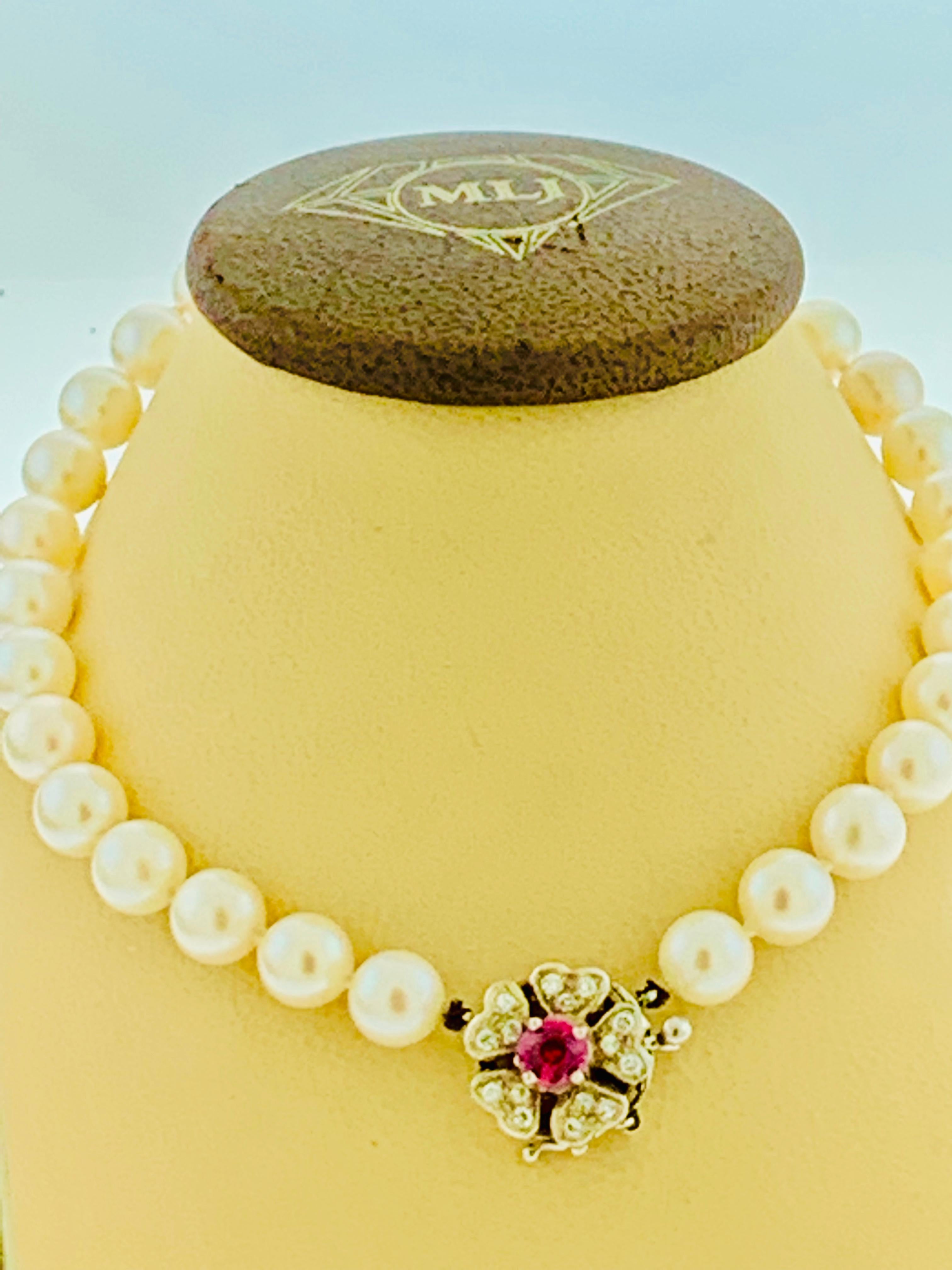 This marvelous vintage Pearl necklace features 1 row of luscious  pearls (measuring approx. 7.25mm - 7.5mm)  with 15 pieces of diamonds and 1 Ruby Gemstone in the clasp
VINTAGE

PRE-OWNED 

 ESTATE PIECE

14K White GOLD 
CLASP IS STAMPED 