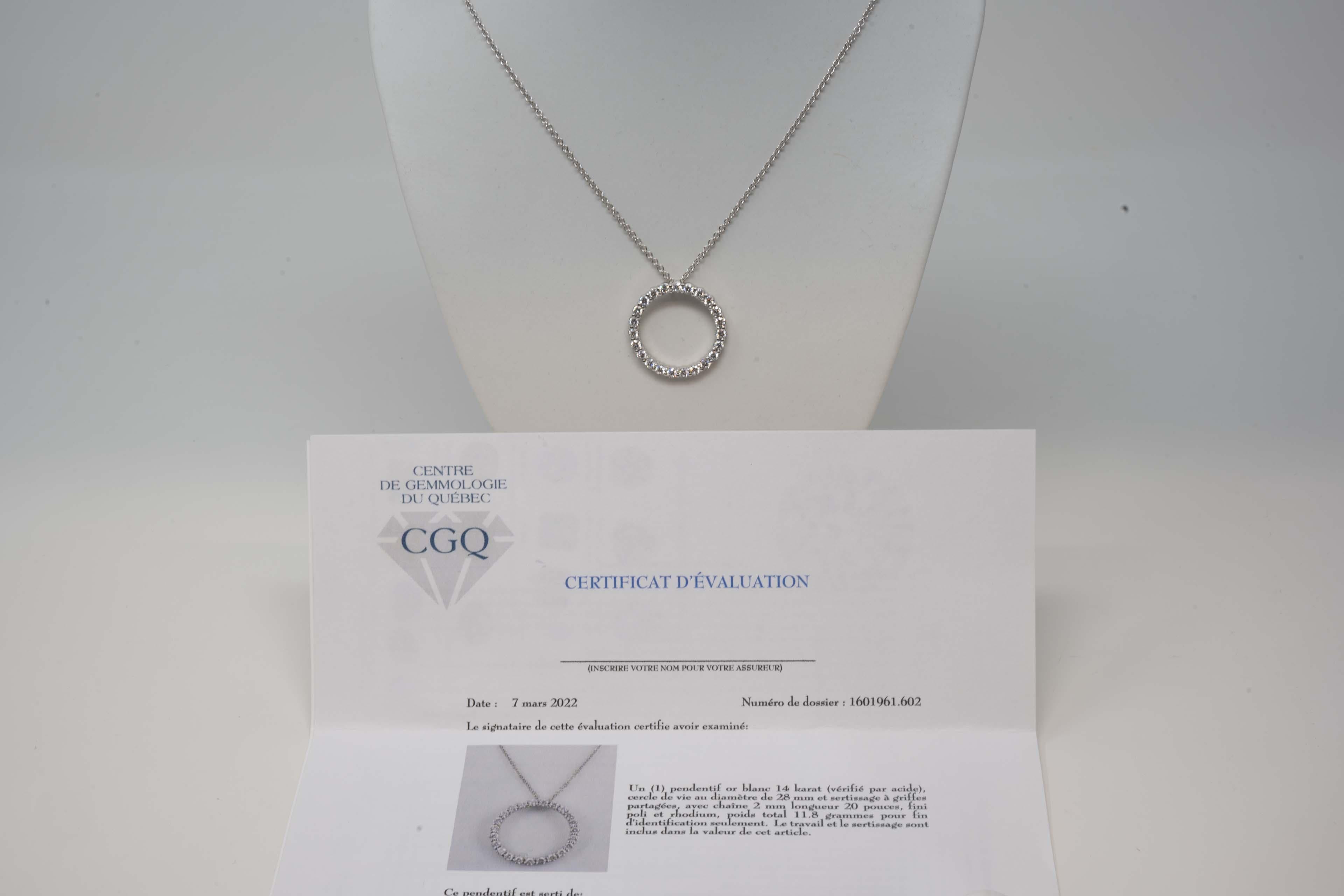 One 14k white gold pendant (acid tested) circle of life shaped with a diameter of 28mm and a chain measuring 2mm x 20 inches. Polished rhodium finish. Weighs 11.8 grams. The pendant is set with twenty-three (23) round brilliant cut diamonds average