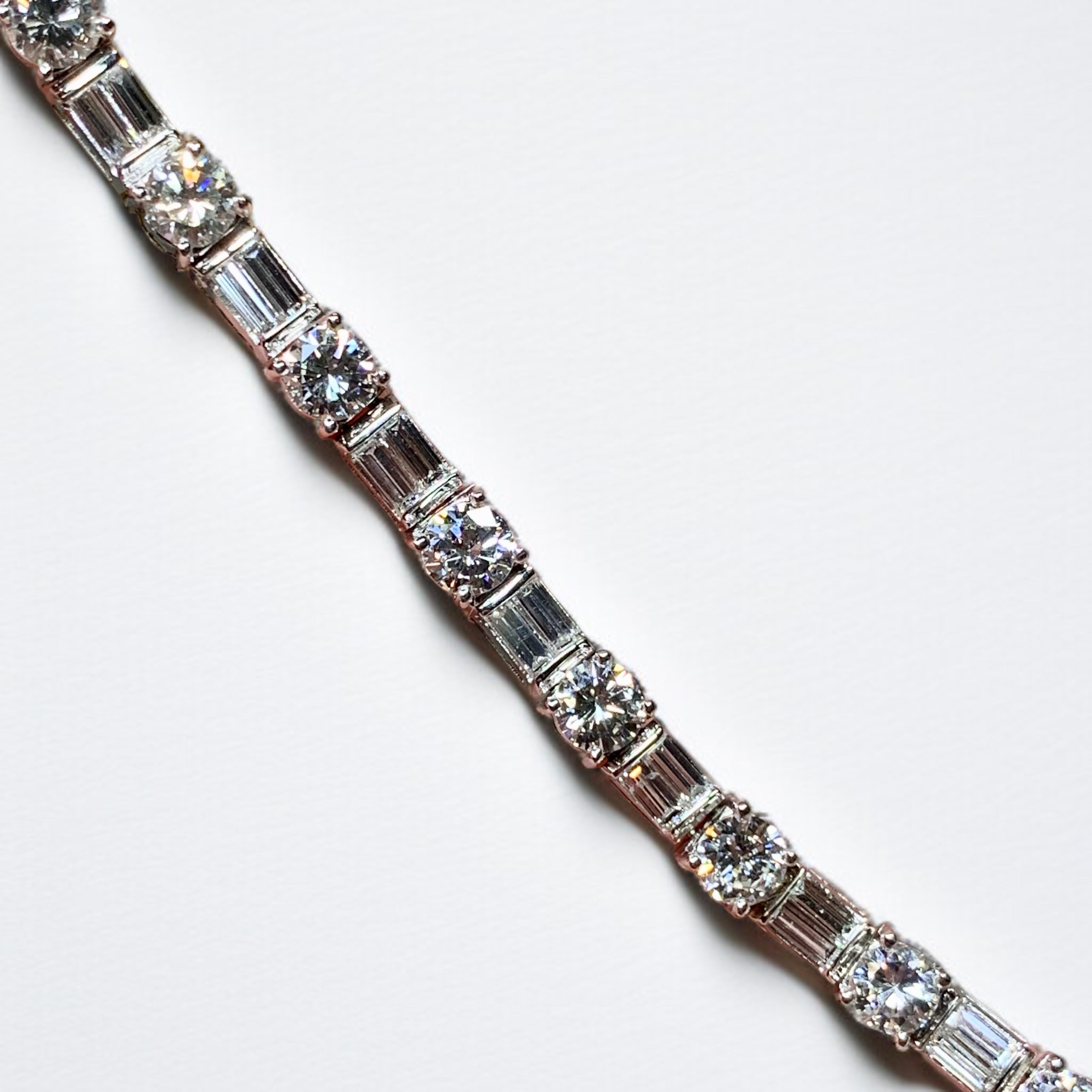 A timeless and traditional line bracelet done in 14K white gold and prong set with exquisitely matched round and baguette diamonds. All stones range G-H in color and Vs1-2 in clarity with the round diamonds weighing between .30ct and .35ct each.