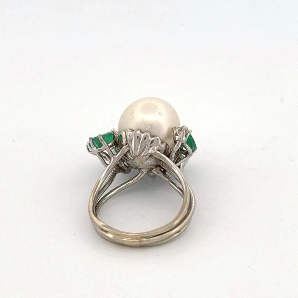 Estate 14K White Gold South Sea Pearl, Emerald & Diamond Cocktail Ring – Size 4.5

Description:
🡆 This estate 14K white gold cocktail ring features a stunning 11mm South Sea pearl with a round to oval shape and moderate surface blemishes, set in a