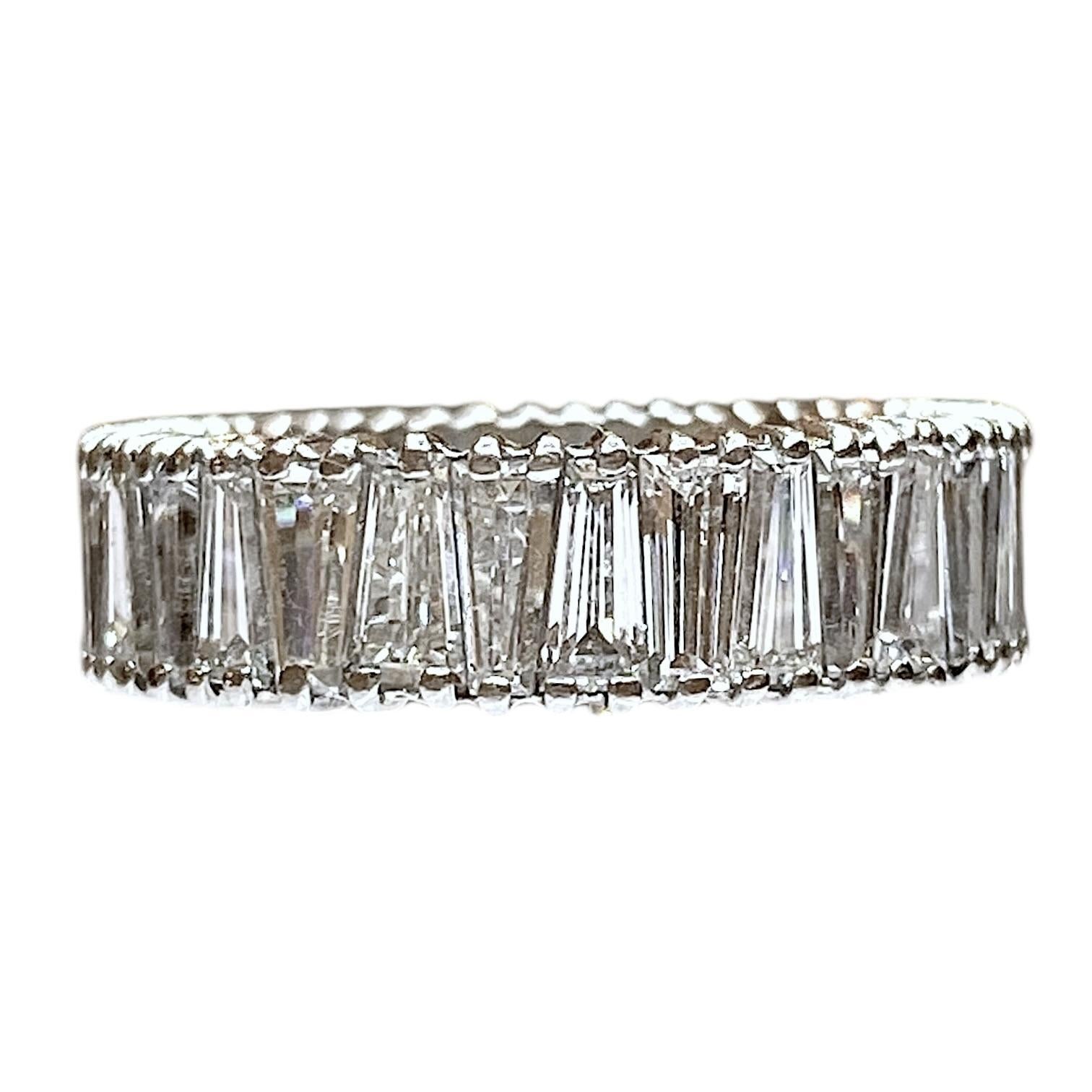Crafted in 14K white gold, this band ring showcases a continuous row of tapered baguette-cut diamonds.
Each stone is set to highlight its perfection. The band is 6 millimeter wide, offering a sleek and modern profile.
Diamonds: 3.00 ctw. Color: G-H,