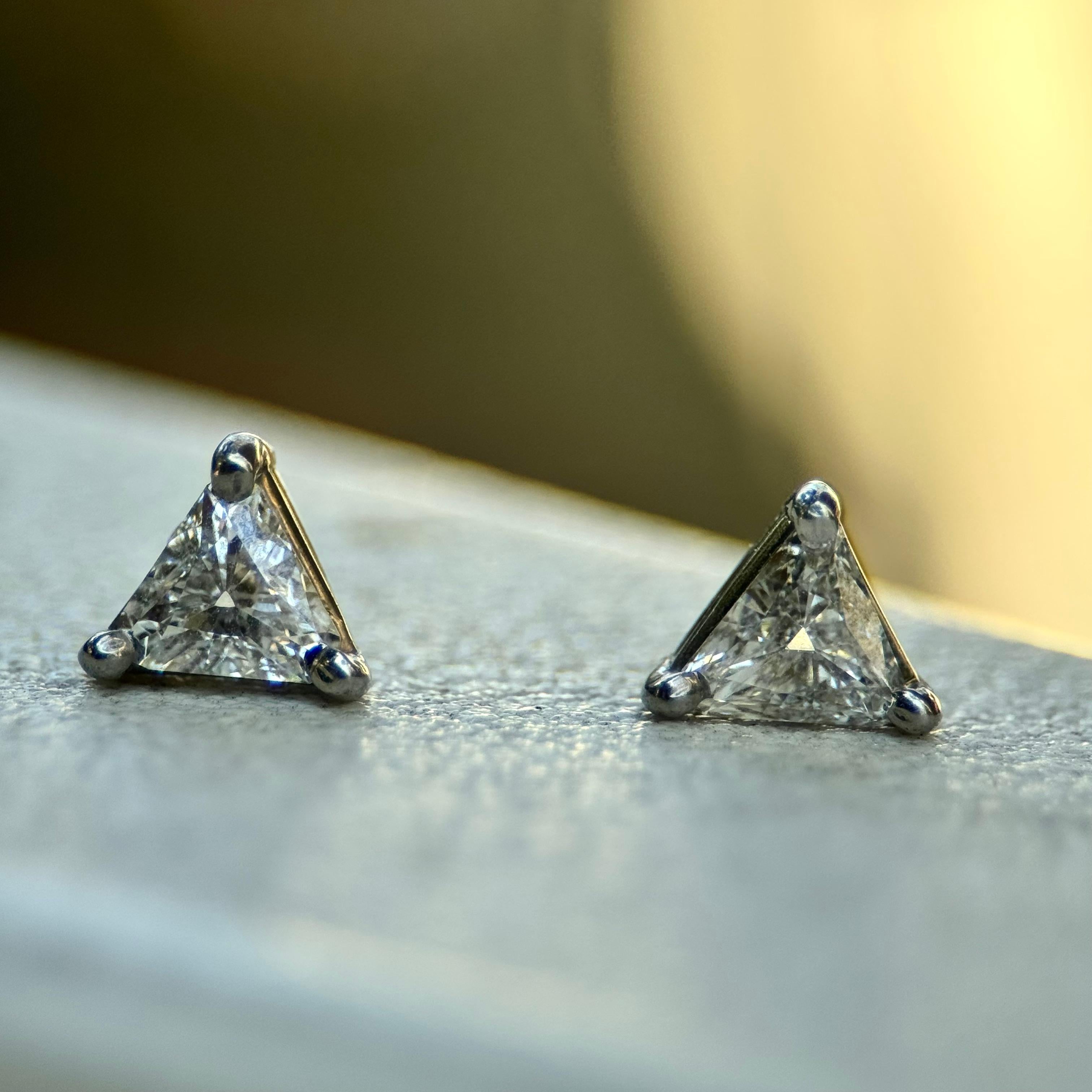 Set in 14k white gold, these beautiful trilliant diamond earrings add a geometric pop of sparkle. They are delicately set so that the diamond is the primary focus, mounted with tiny prong settings in each corner. A refreshing alternative to the