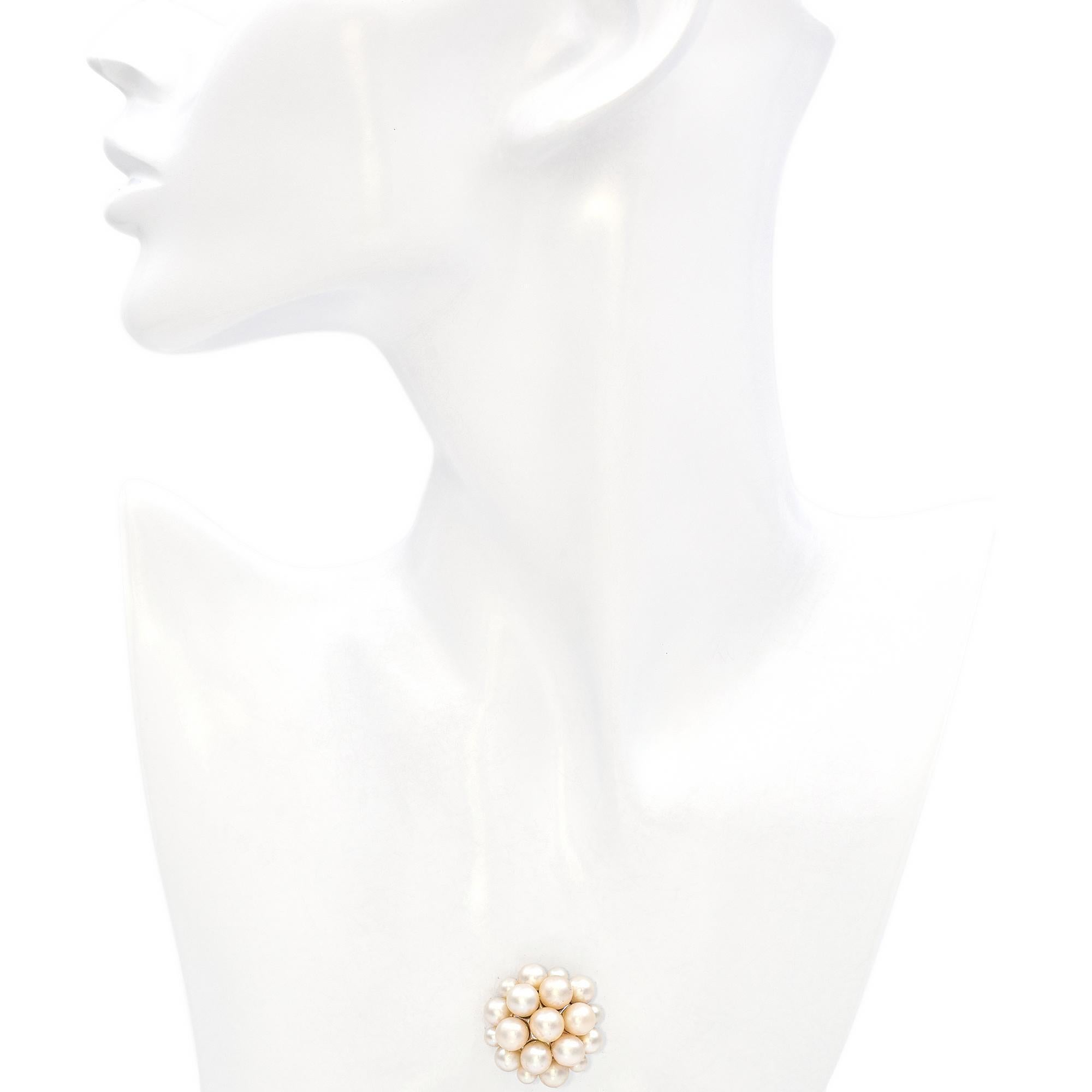 This brooch effortlessly blends elegance and sophistication, featuring a cluster of luminous white pearls. Crafted in 14k white gold, the design thoughtfully arranges pearls of varying sizes, creating a dynamic and captivating composition. The
