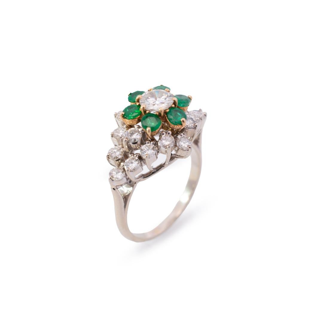 Gender: Ladies

Metal Type: 14K White & Yellow Gold

Size (US):

Width: Approximately 15.00mm tapering to 1.80mm

Diameter: 21.80mm

Weight: 5.16 Grams
This beautiful diamond cocktail ring is accented with 6 natural round emeralds with a half round