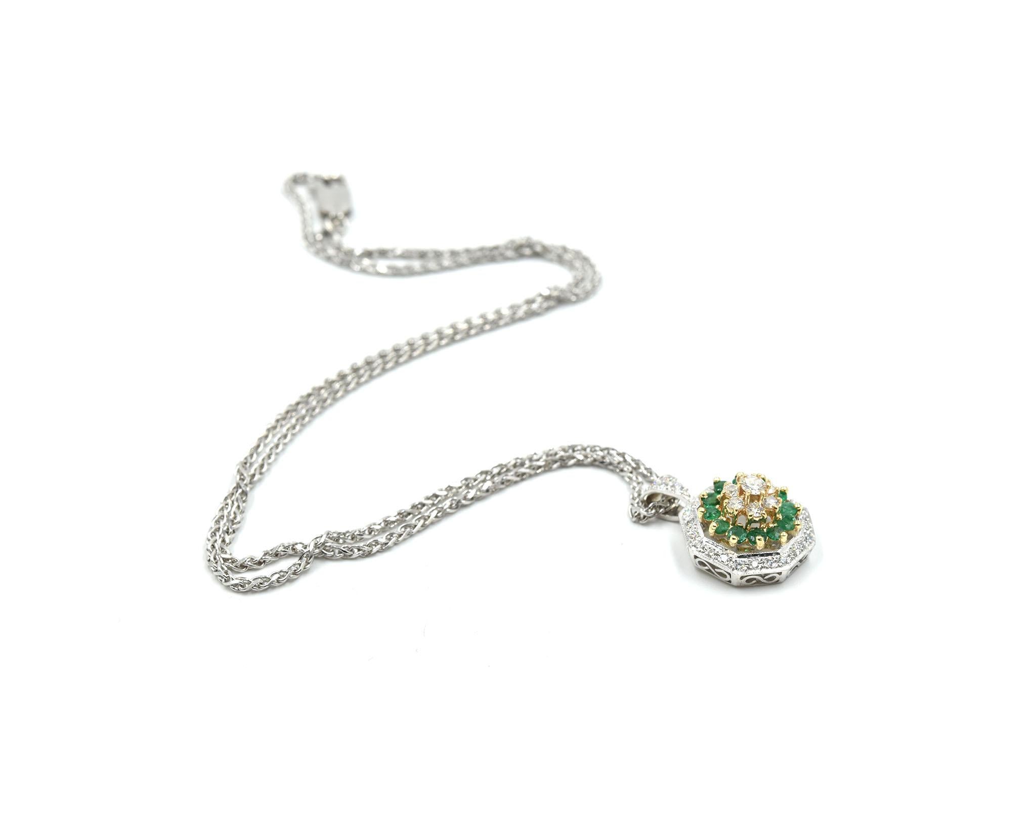 This necklace is made in 14k yellow and white gold. It features 35 round brilliant-cut diamonds with a total weight of 0.57ct. It also features 12 emerald stones with a total weight of 0.60ct. The pendant is an octagon shape and measures 15x21.5mm