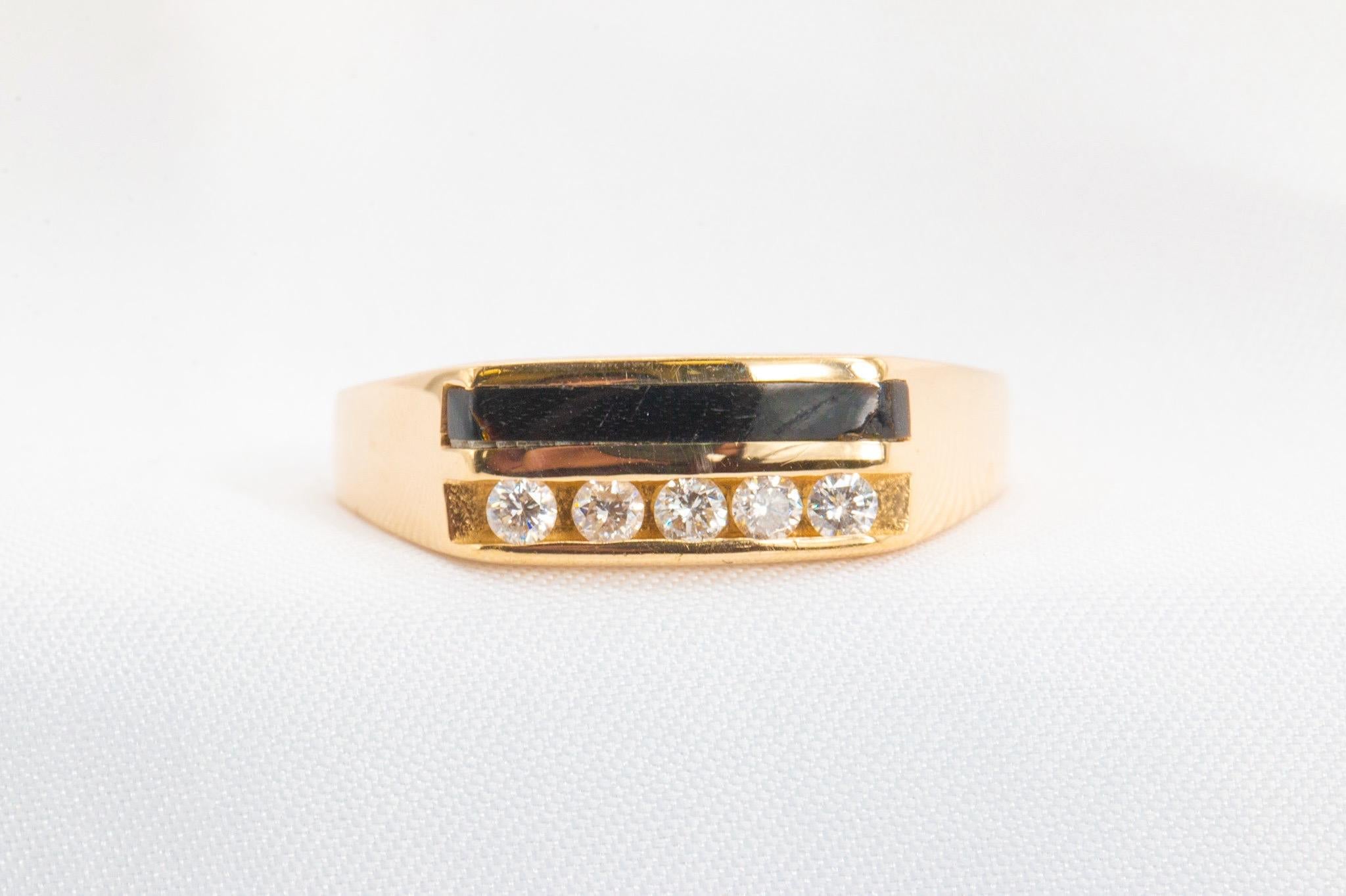 1980s Vintage 14K Yellow Gold 0.25CT Diamond and Onyx Ring

The channel in this ring features five approximately 0.25CTW round brilliant diamonds, graded G-H in color and VS2-SI1 in clarity, next to an inlaid piece of natural black onyx. 

The band