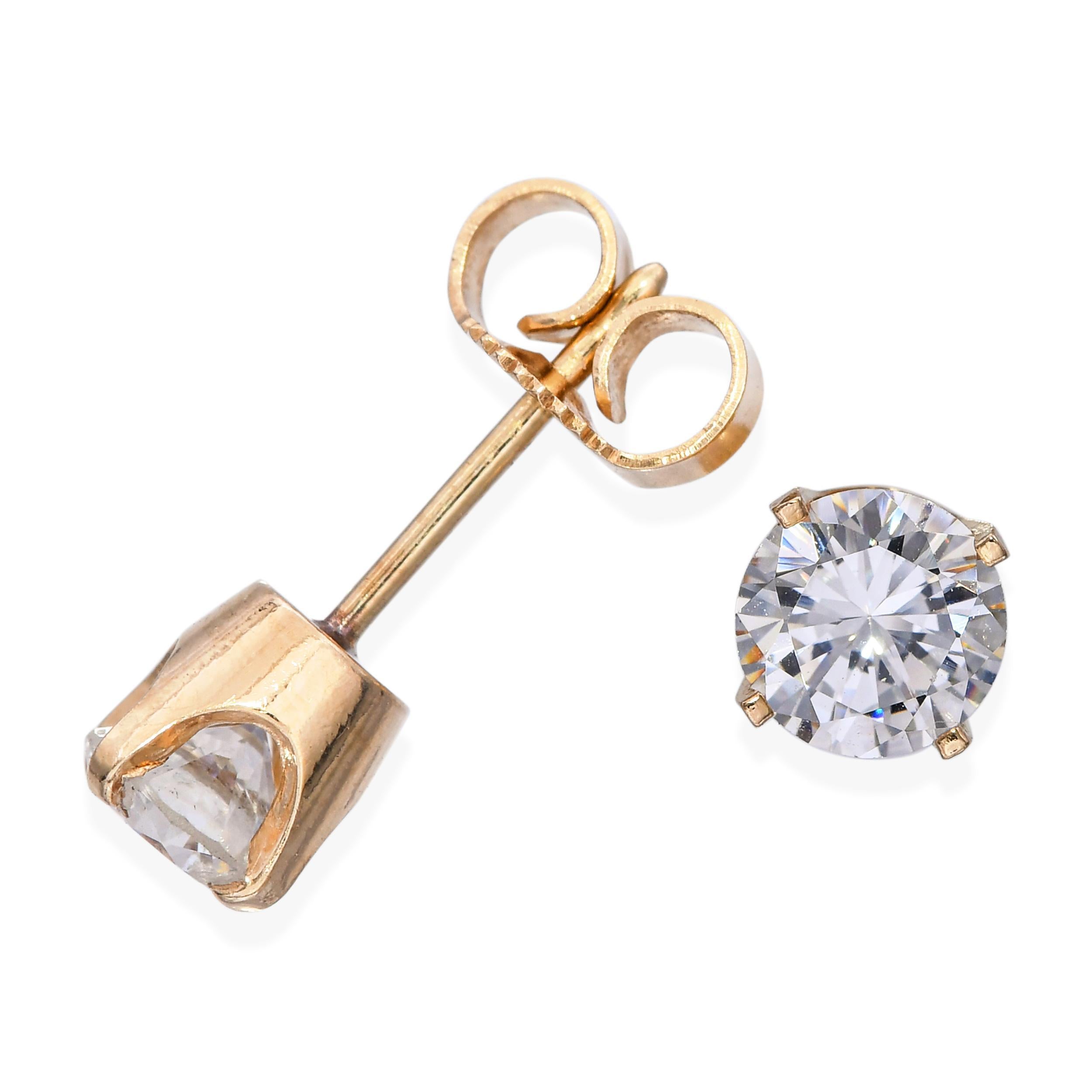 These vintage 14k yellow gold diamond stud earrings feature two round brilliant-cut diamonds totaling 1.01 carats, graded L color and Si1 clarity. Each diamond is securely four-prong set, allowing maximum light exposure for a beautiful sparkle that