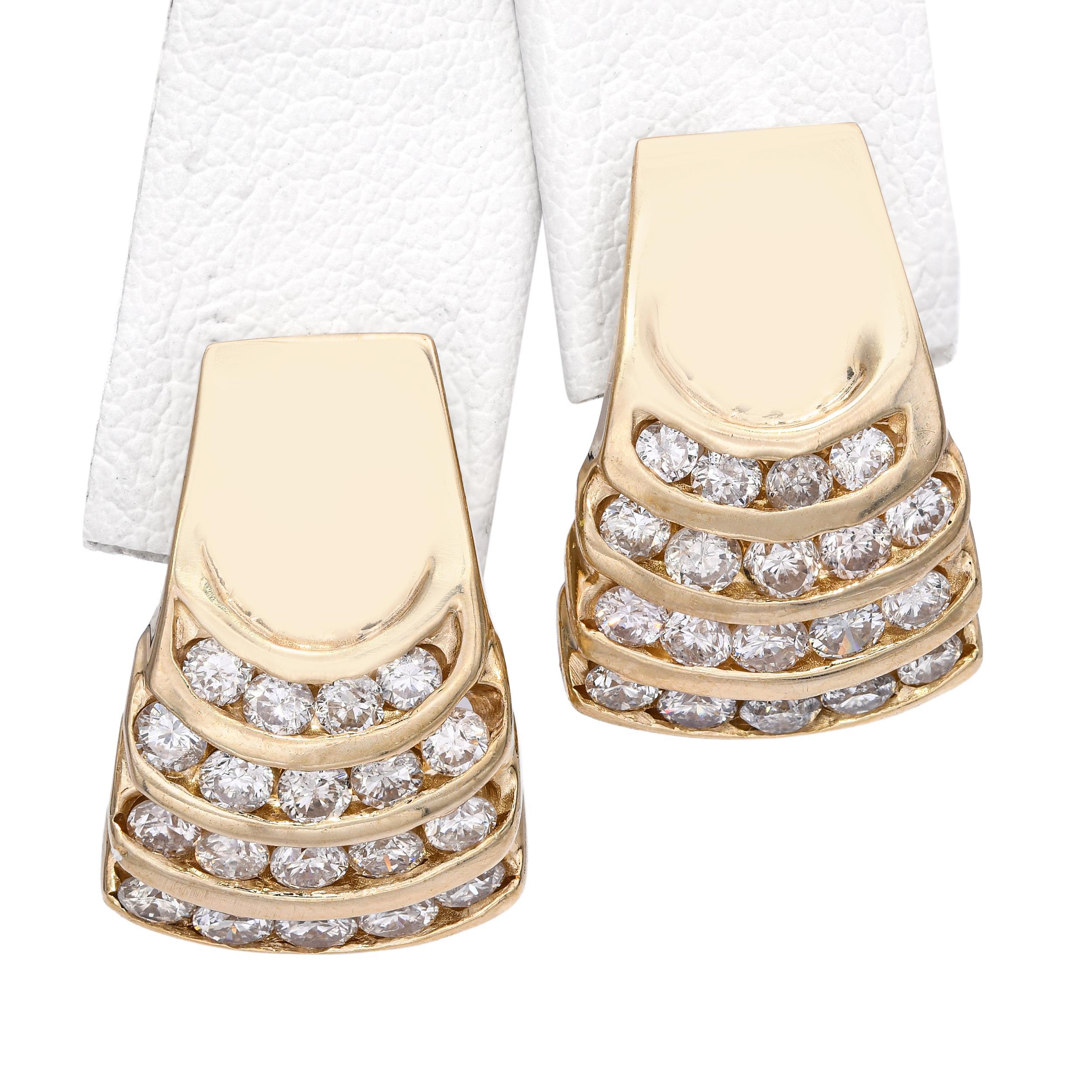 Refined and timeless, these vintage earrings are crafted in 14k yellow gold and feature a bold, sculptural design accented with three graduated rows of sparkling round diamonds. The softly curved silhouette adds depth and dimension, creating a