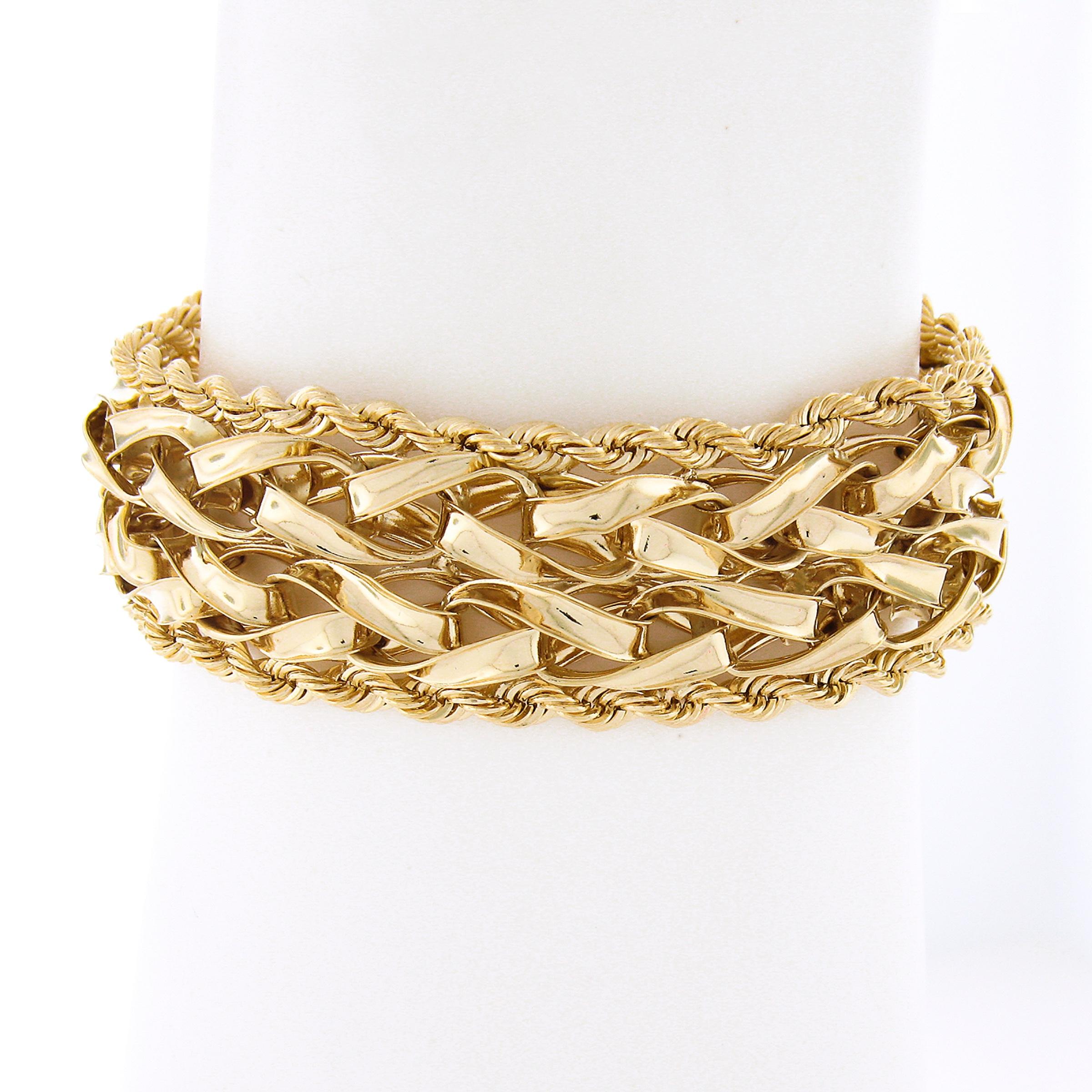 You are looking at a gorgeous and well made vintage bracelet that's crafted in solid 14k yellow gold. This unique wide bracelet is constructed from a uniquely braided link center with high polished finish and further two rope link chains on both