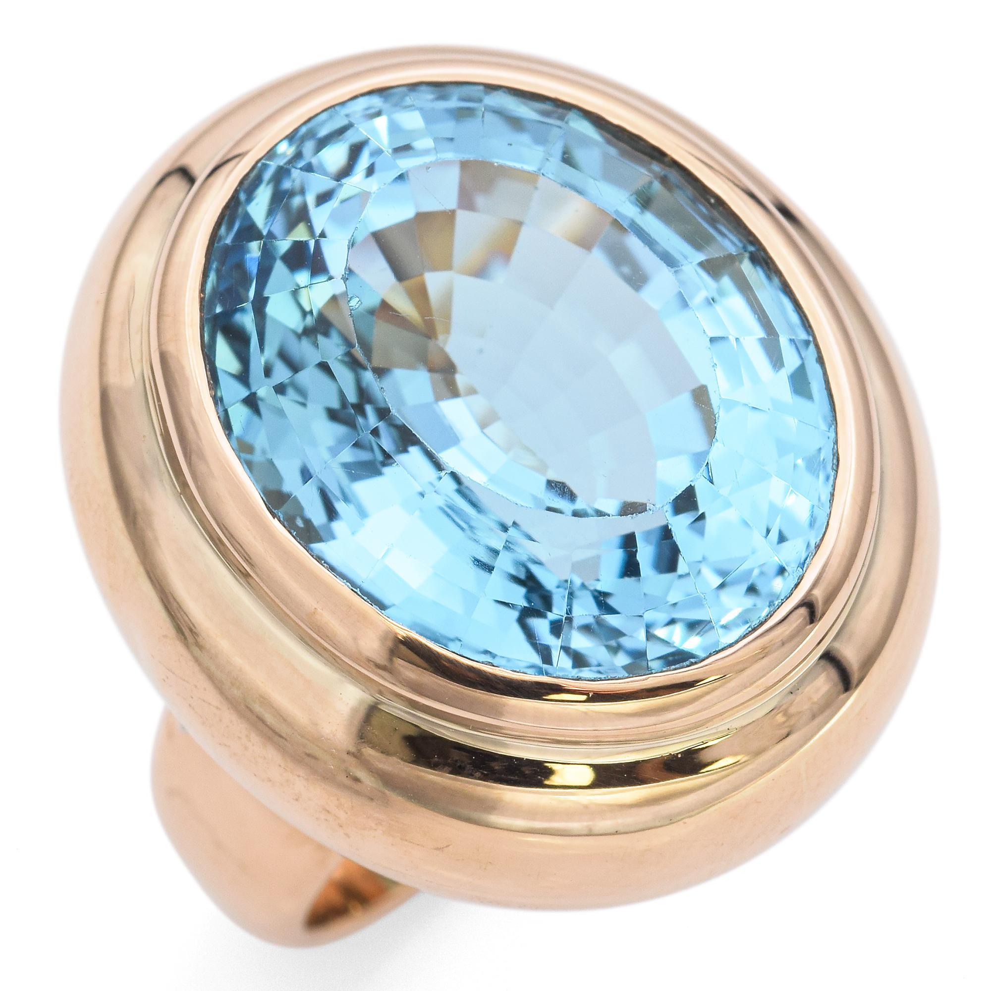 A big bold and striking blue topaz ring.
It features a large, oval-cut beautiful blue topaz with a vibrant sky-blue hue. The gemstone is set in a smooth, polished gold bezel, enhancing its brilliance and depth.
The ring's band is crafted in warm