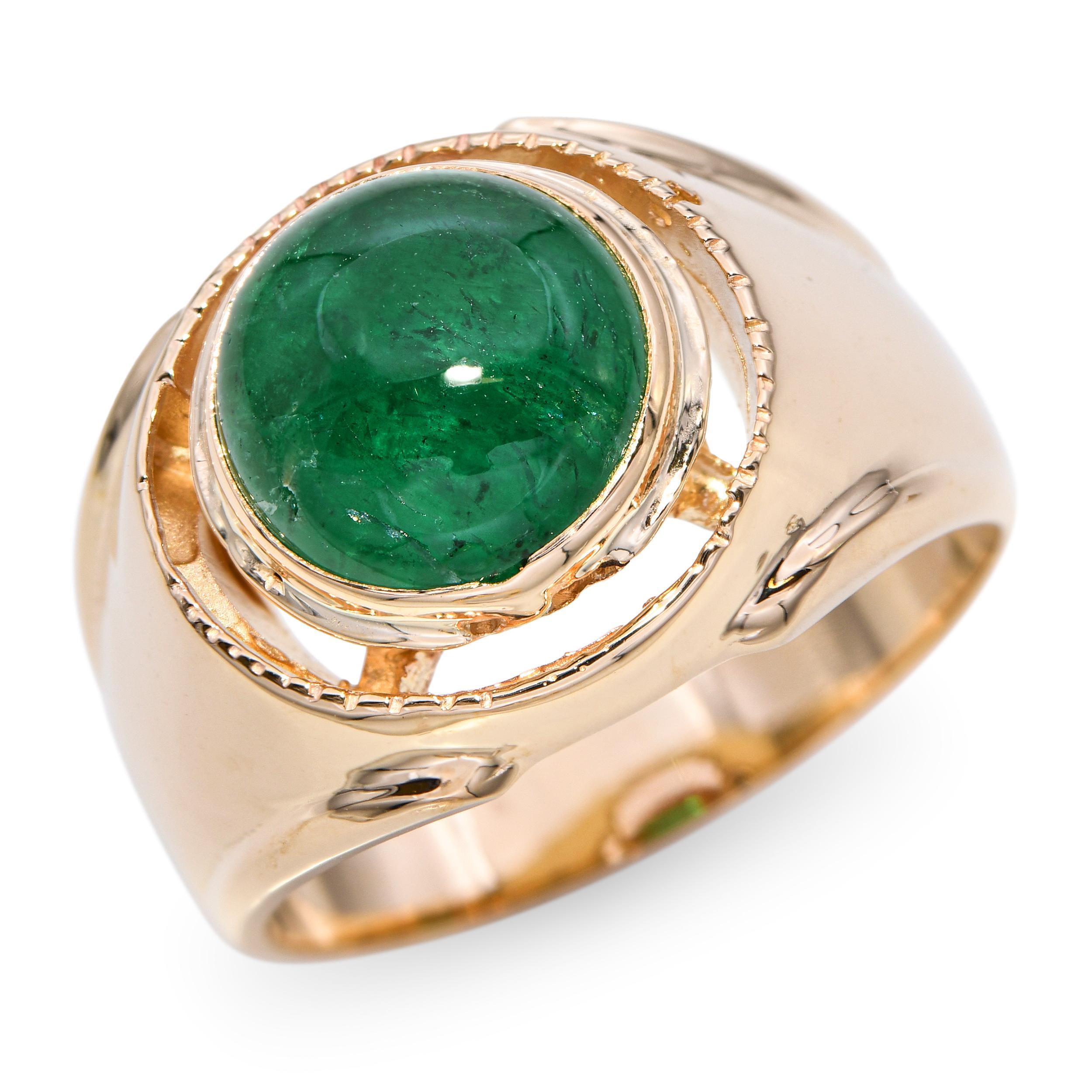 This vintage 14k yellow gold ring features a 3.54-carat emerald cabochon that displays rich green color and smooth polish. Its rounded cabochon cut highlights the natural beauty and depth of the stone, giving the ring a classic, understated