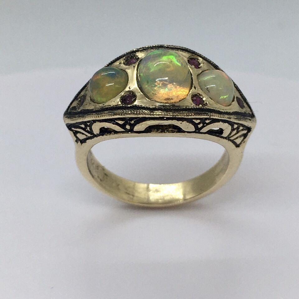 Vintage 14k Yellow Gold 7.0 Gram Natural Opal Ruby Statement Ring Size 6.5


Size 6.5
 Center Opal 5mm by 7mm, sides 4.5 mm round sides 
11mm wide & 21 mm long on top 
14K yellow gold tested and marked 
Weighting 7.0 gram
Heavy and healthy, looks