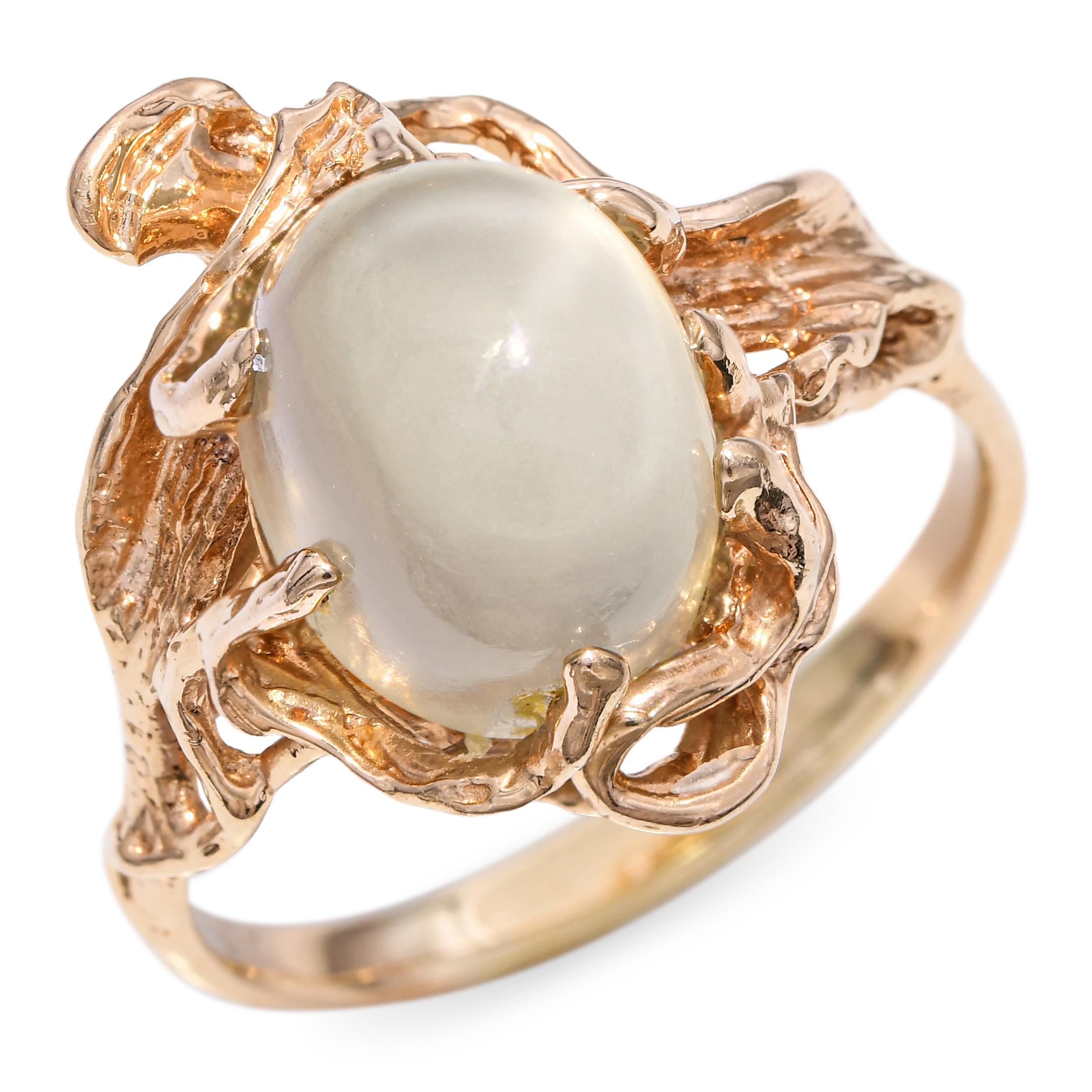 A striking vintage statement ring crafted in solid 14k yellow gold with a naturalistic vine and branch motif. The centerpiece is a smooth cabochon moonstone with a soft, glowing sheen that shifts beautifully in the light. The organic, sculptural