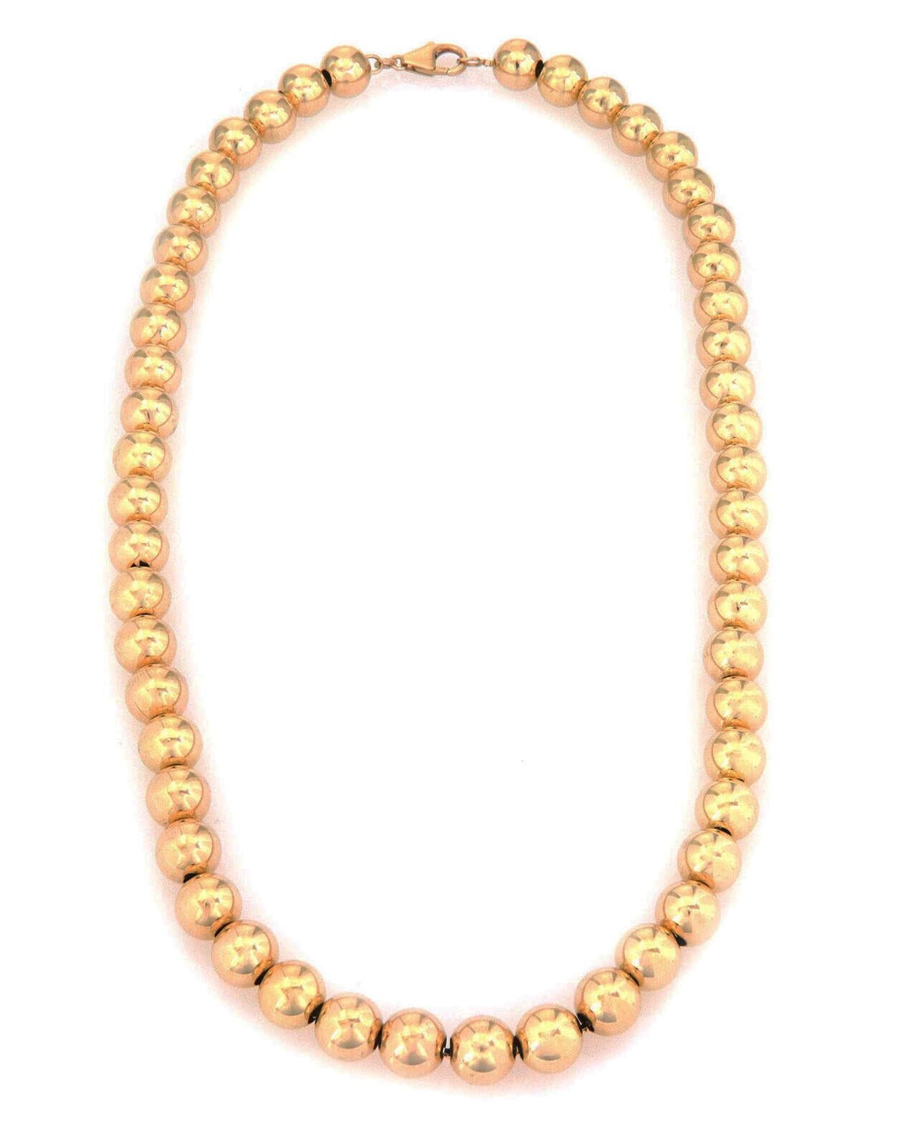 This is a lovely classic style beaded necklace, crafted from 14k yellow gold with a high polished finish featuring 9mm strung gold beads on a 1mm box link yellow gold chain. It secures with a lobster clasp and has the 14k gold content
