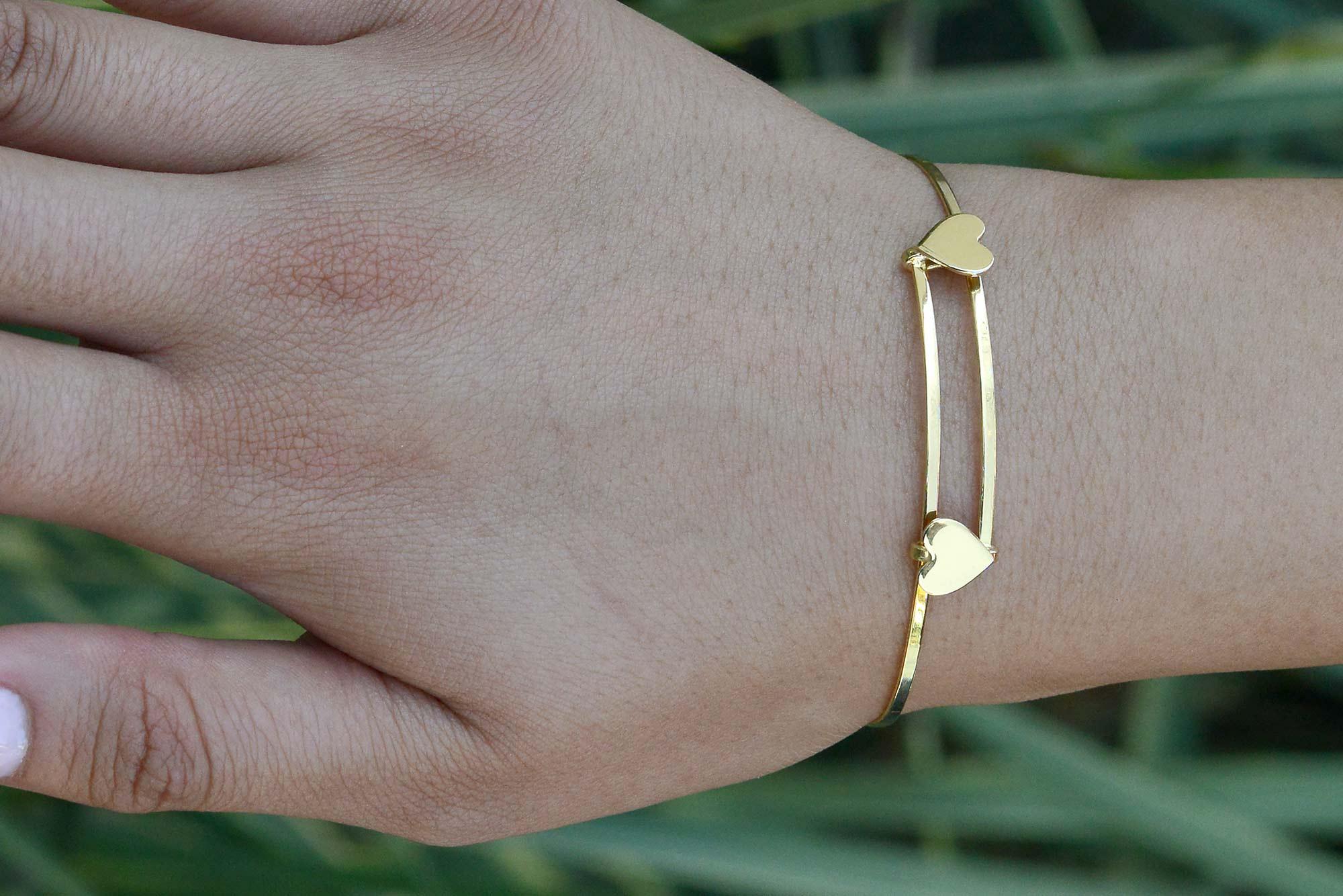 This lovely twin heart bracelet makes for a perfect stacking bangle. This vintage 1980s 14k yellow gold heirloom would be the perfect gift to a special person in your life or show some love to yourself! You can't go wrong with an effortless,