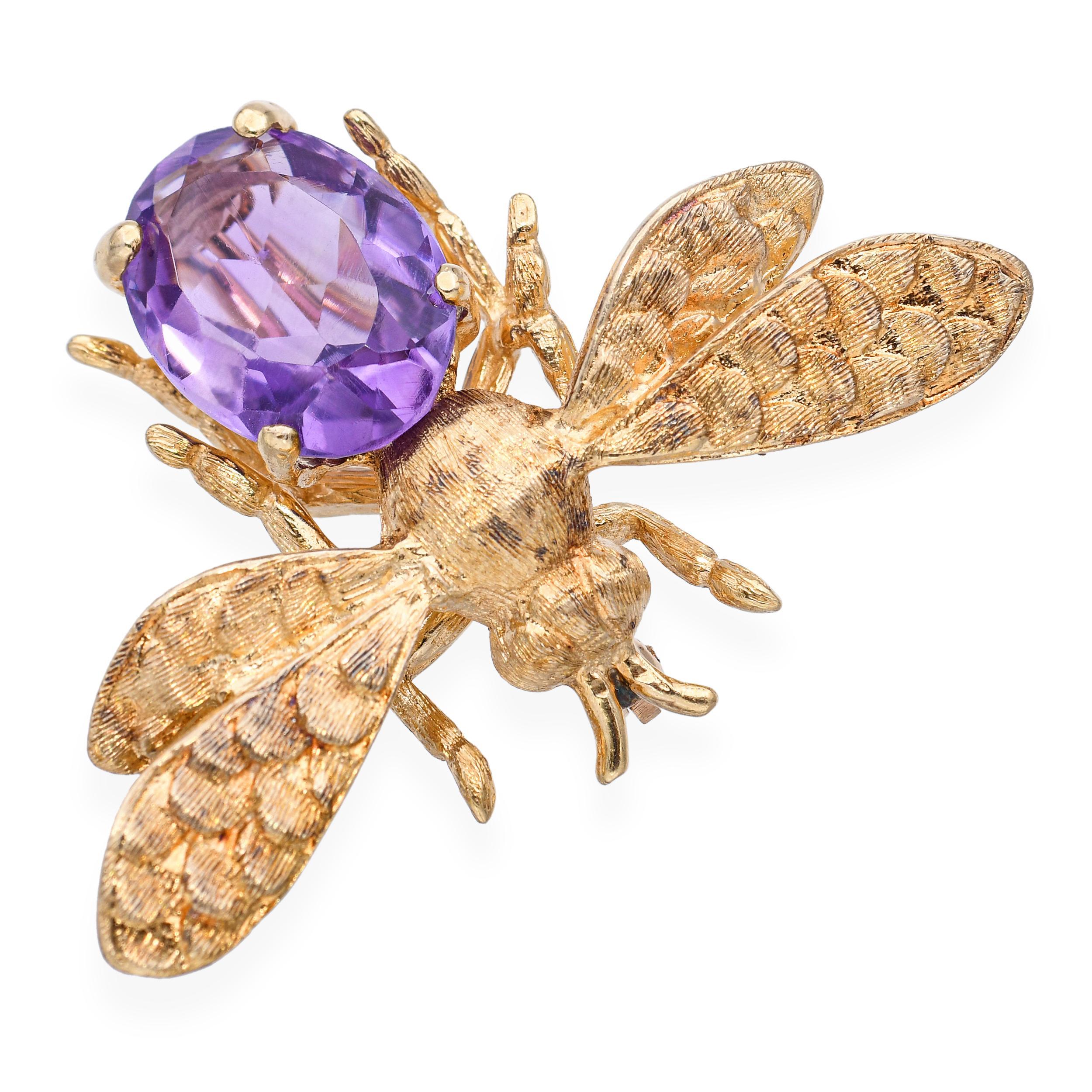 Vintage 14k yellow gold bumblebee brooch featuring a vibrant amethyst gemstone body. Beautifully detailed wings and delicate craftsmanship bring this whimsical design to life, blending playful charm with elegant vintage appeal. A standout