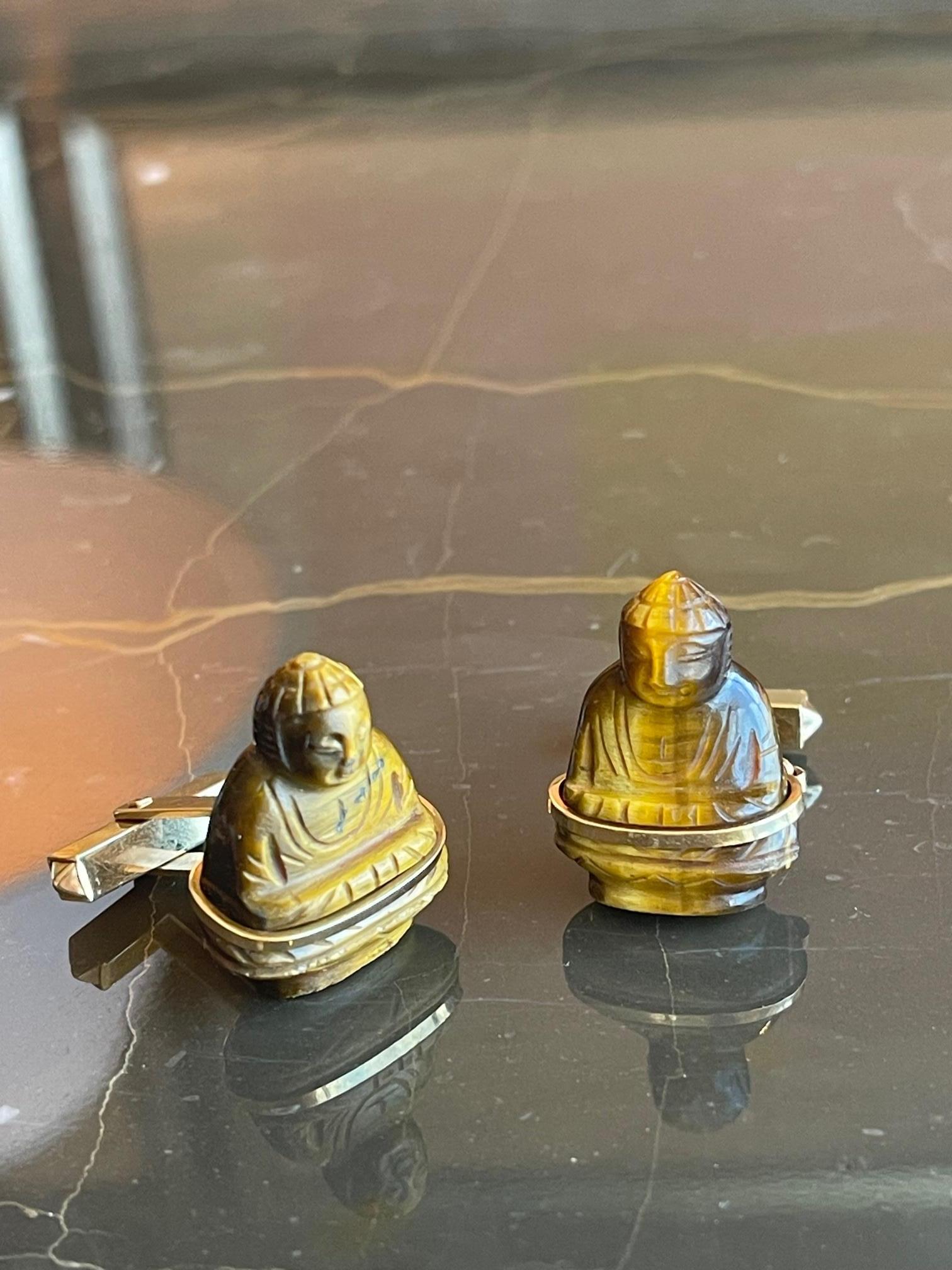 Fabulous and substantial 14k Yellow Gold and Carved Tiger's Eye Vintage Buddha Cufflinks. The luxurious hue of the carved tiger's eye is elegant and classic. The buddhas are meticulously carved and a perfect pair. The gold wrapping the cufflinks is