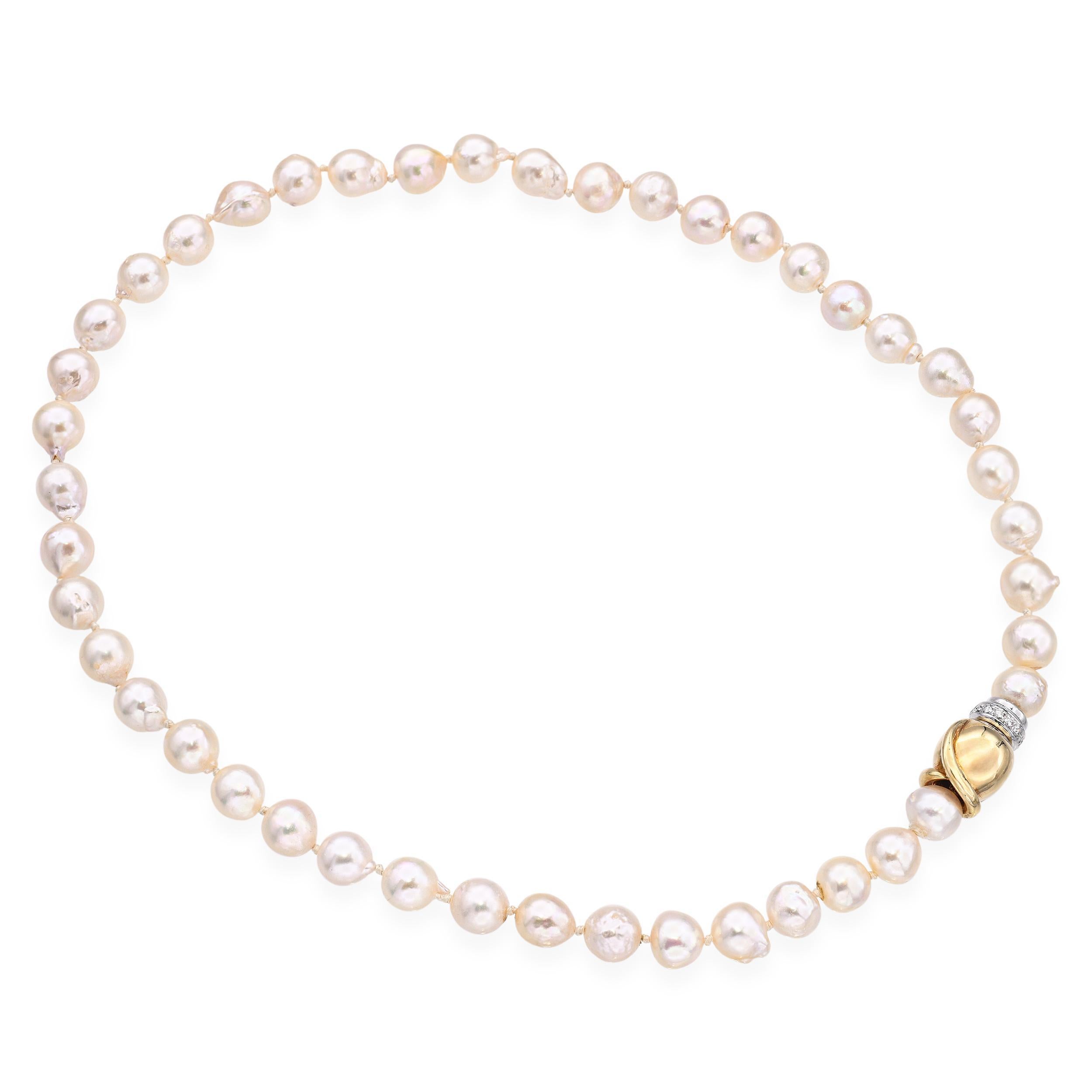 This vintage pearl necklace has character — each semi-baroque pearl is unique, with natural shapes that catch the light beautifully. The warm 14k yellow gold setting feels classic, and the diamond clasp shaped like a rose adds a subtle, elegant