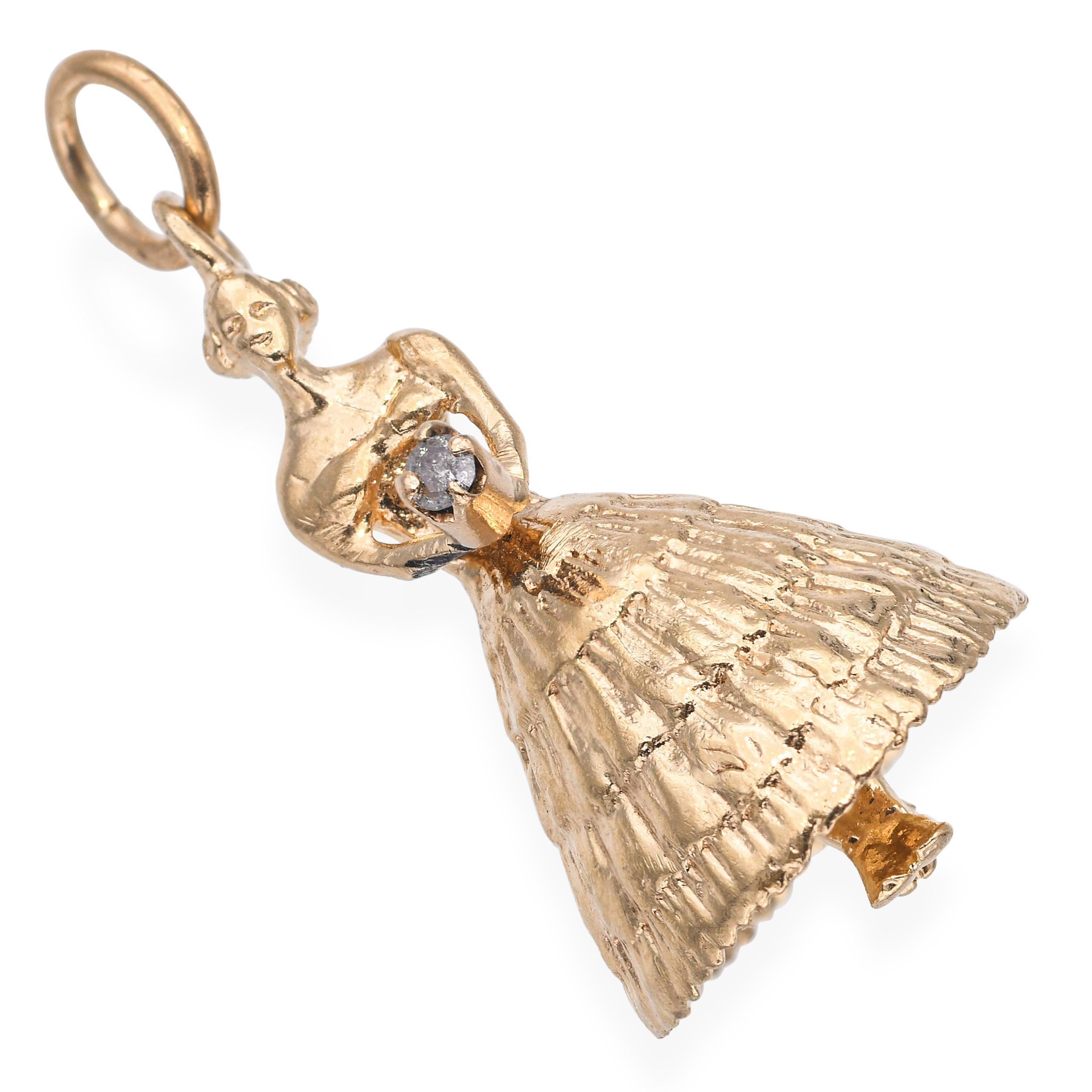 This whimsical vintage pendant is crafted in 14k yellow gold and depicts a finely detailed flower girl. A sparkling diamond accent adds a touch of brilliance, enhancing the charm’s refined design. The intricate craftsmanship captures graceful