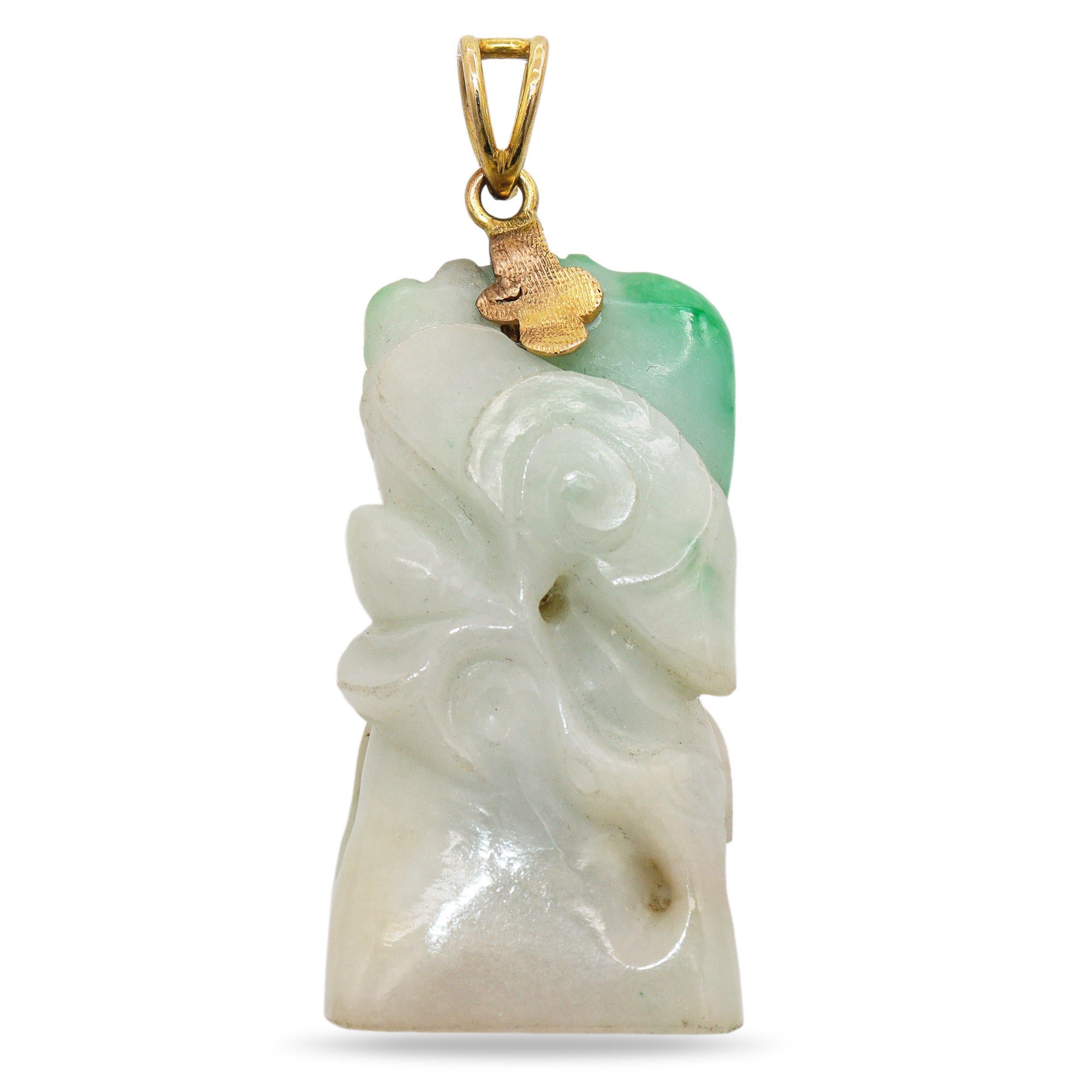 A lovely natural jade pendant carved in soft, flowing forms with light apple-green accents blending into a milky white base. The piece showcases traditional Chinese carving motifs with graceful scrollwork and symbolic shapes representing harmony and