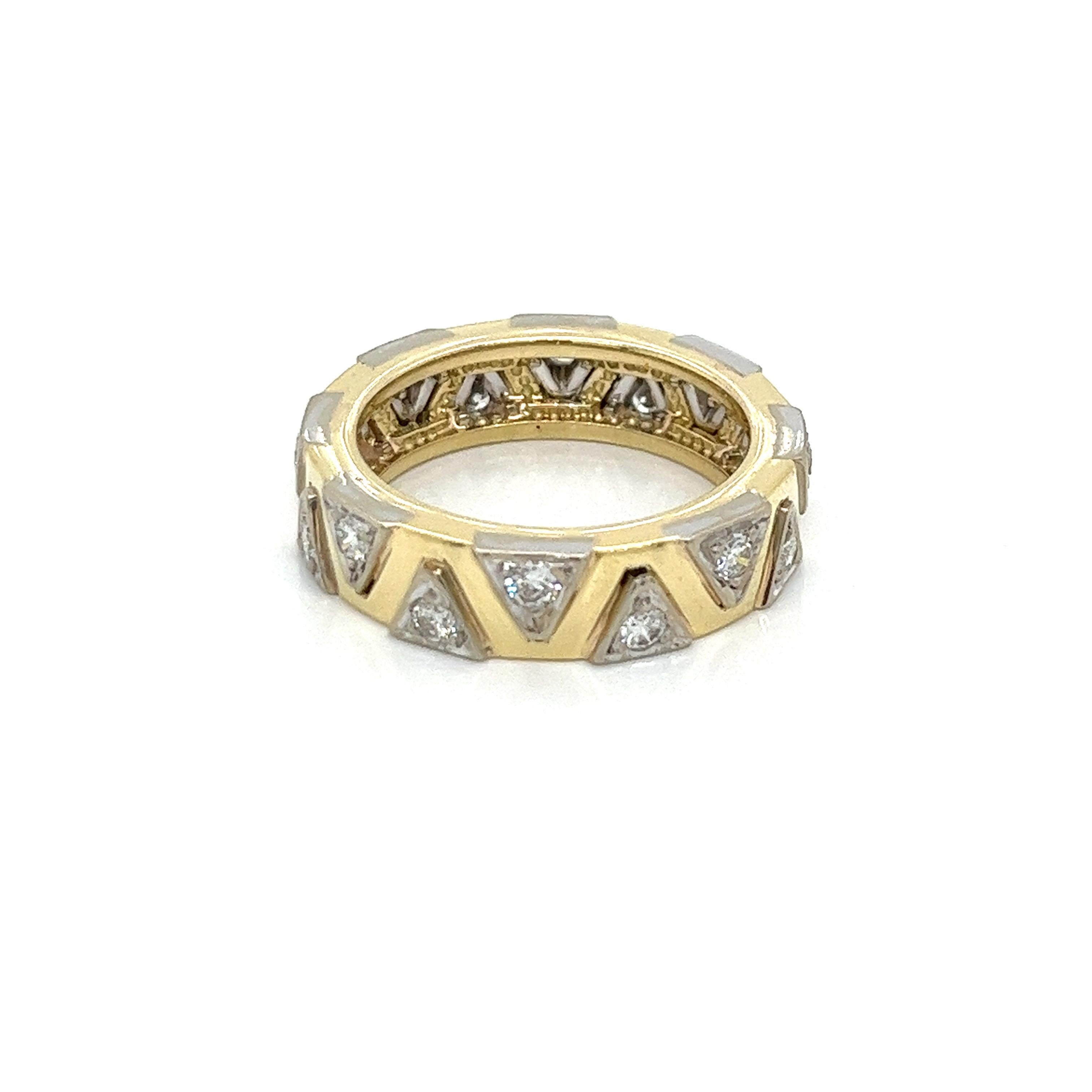 Vintage 14K Yellow Gold and White Gold Diamond Eternity Band. The band is set with 16 round diamonds weighing approximately .70ct total weight with a quality of G-H color and VS2 - SI1 clarity. The diamonds are set in white gold triangle shape