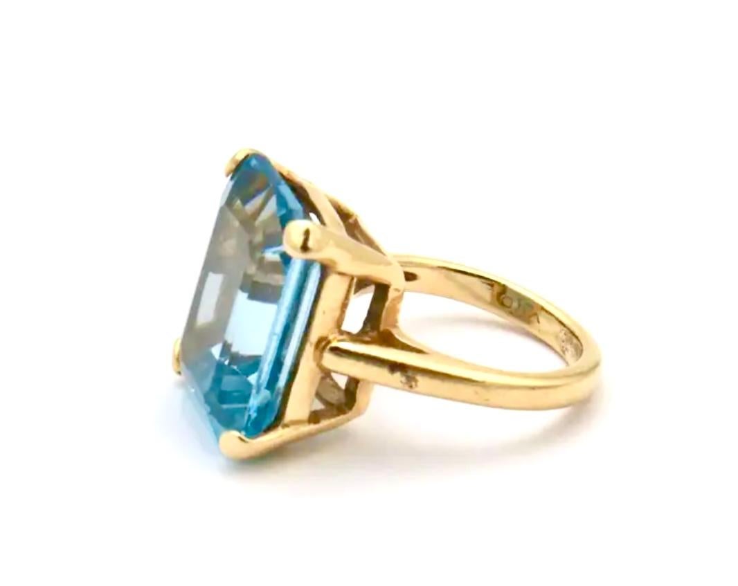 Stunning 14K yellow gold with emerald cut Aquamarine cocktail ring, Approximate size 5. Approximately 12 total carats.  Total Weight approximately 7 Grams.