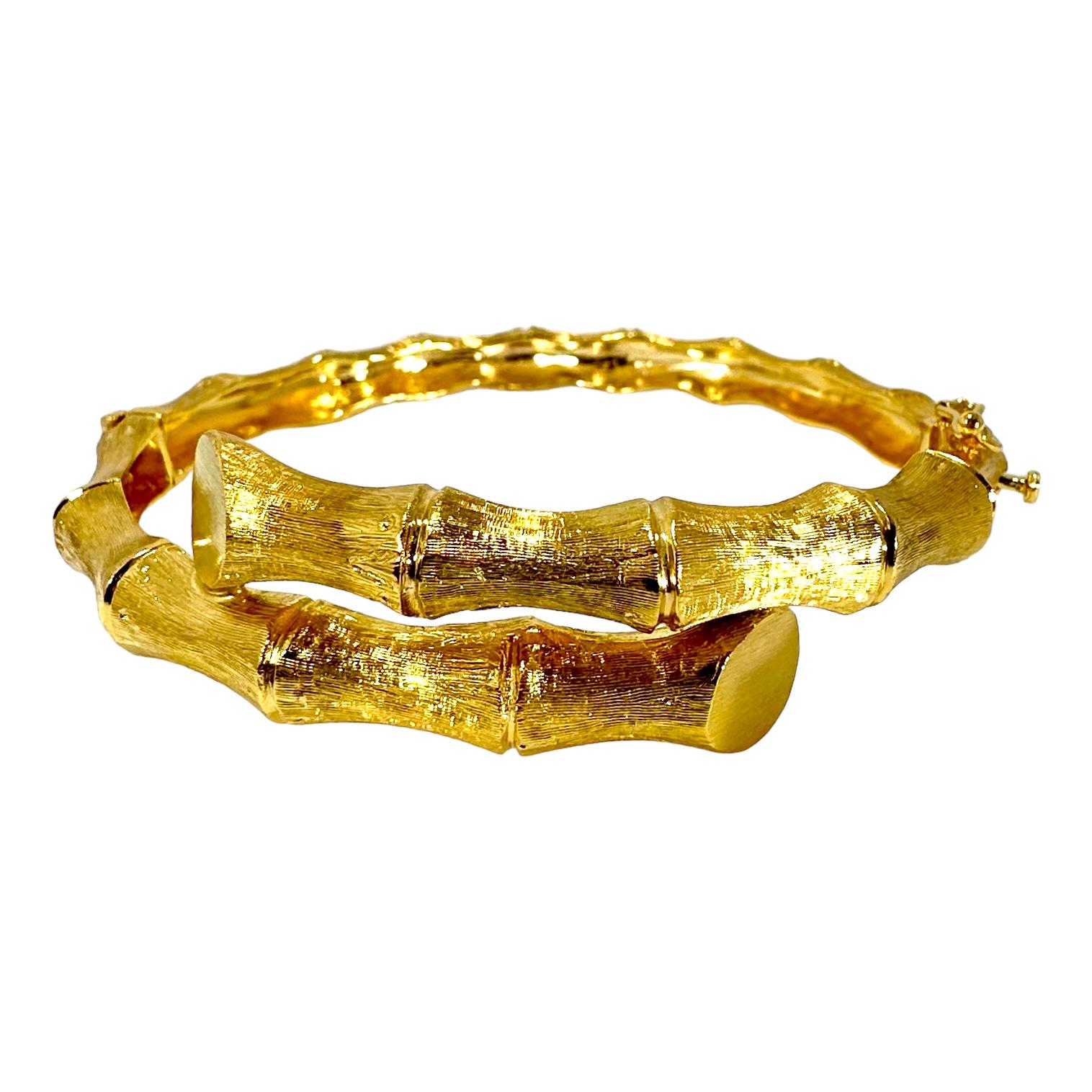 This tailored, bamboo motif, 14K yellow bypass bangle bracelet is a beautiful example of this genre. At the front, in the center, the bracelet measures almost 3/4 inch in width and tapers down to 1/4 inch at the rear. Every surface is single