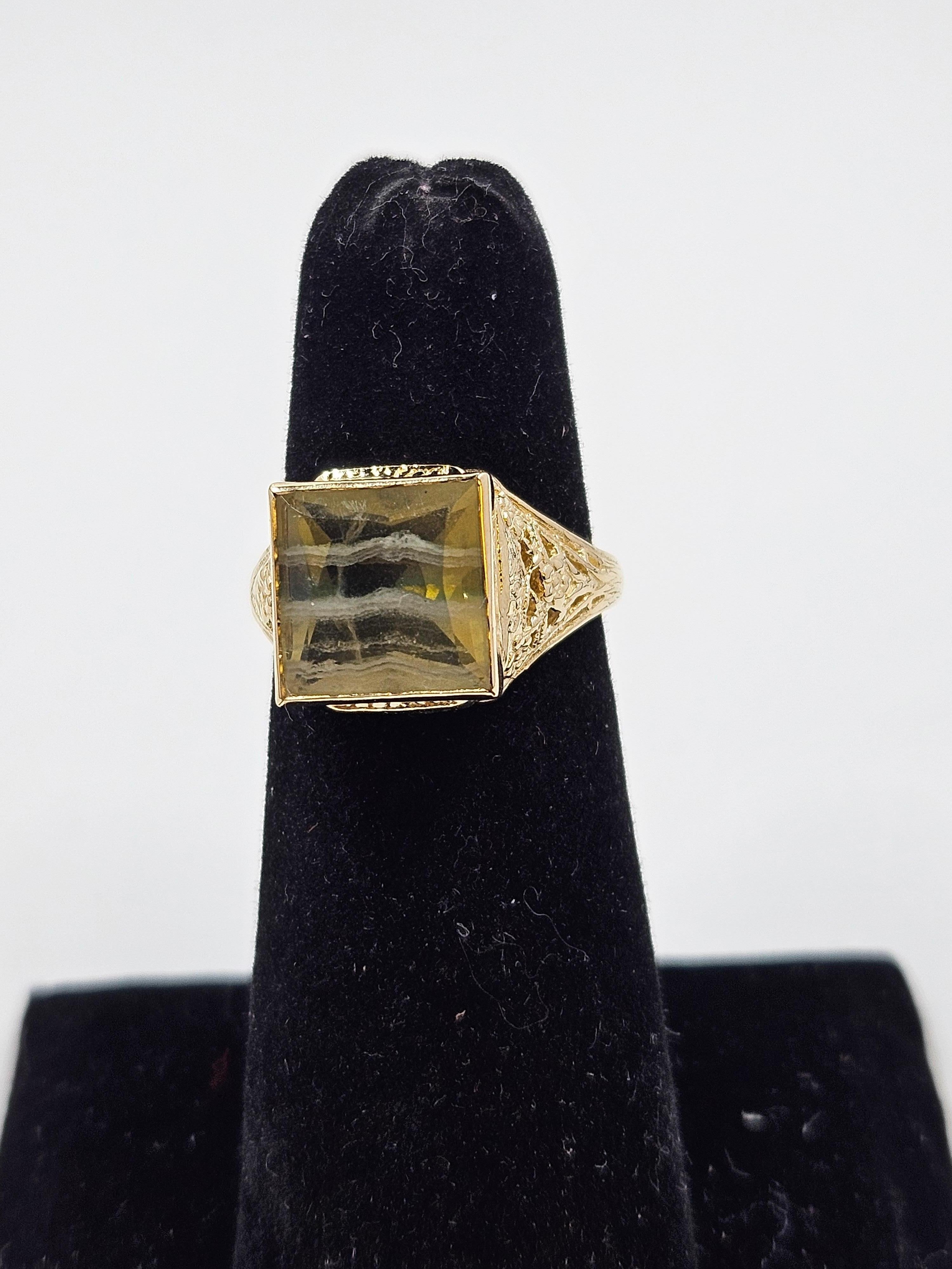 Vintage 14K yellow gold banded fluorite filigree ring. This beautiful filigree design 14K yellow gold ring features an 11mm square cut banded fluorite stone. Ring is a size 7.