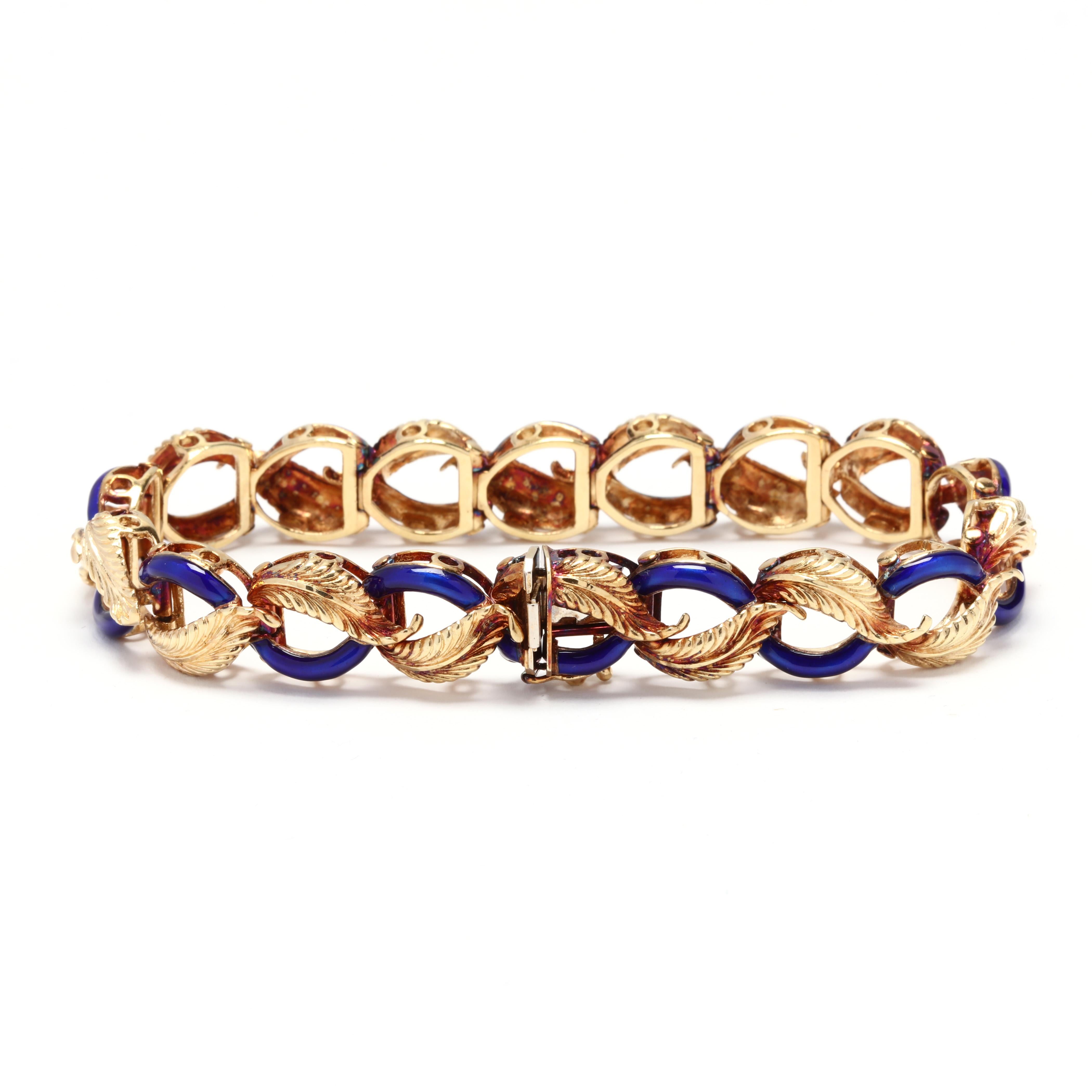 A vintage 14 karat yellow gold and blue enamel leaf bracelet. This bracelet features curved leaf motifs in a rounded zig zag pattern with alternating cobalt blue enamel links with a box clasp.

Length: 7.5 in.

Width: 1/2 in.

21.72 dwts.

* Please