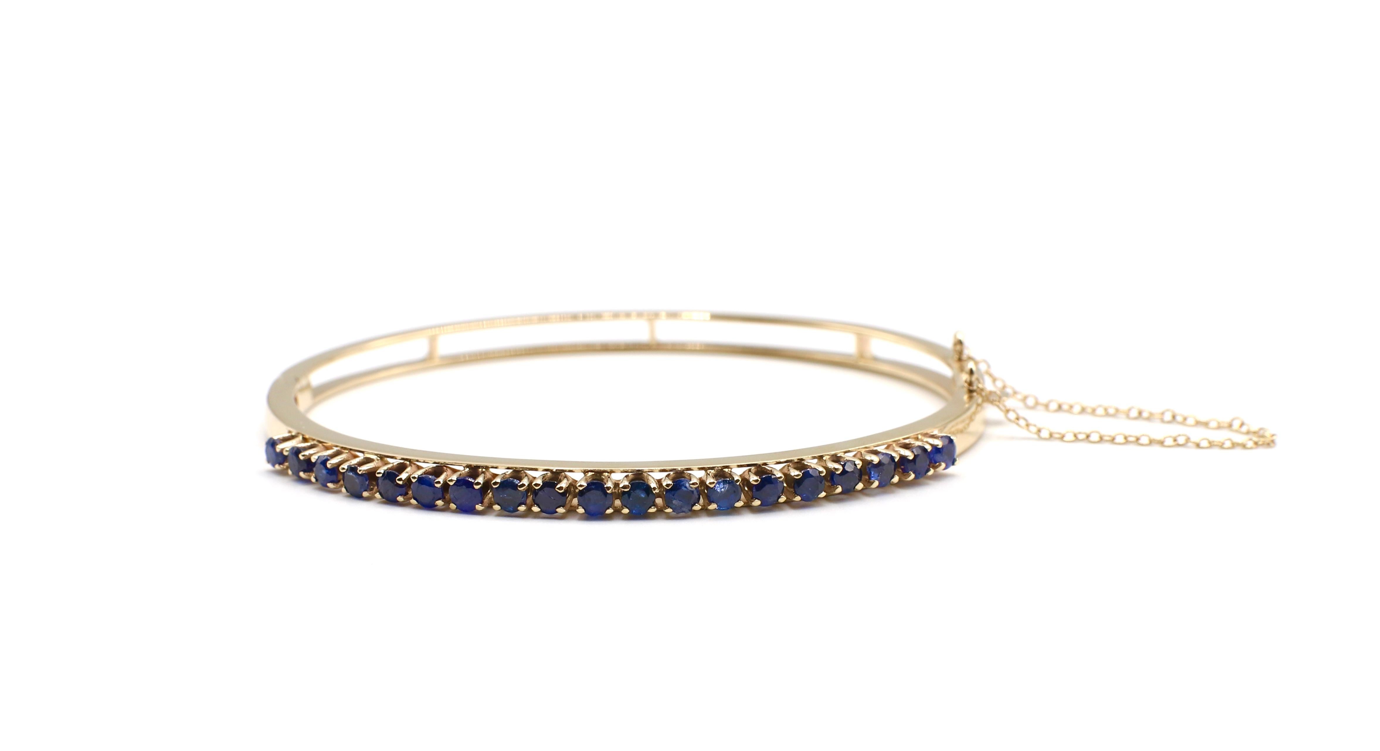 Vintage 14K Yellow Gold Blue Sapphire Hinged Bracelet Bangle

Metal: 14k yellow gold, marked 14k
Weight: 10.54 grams
Sapphires: 19 round blue sapphires, approx. 2.85 CTW
Diameter: 2.5