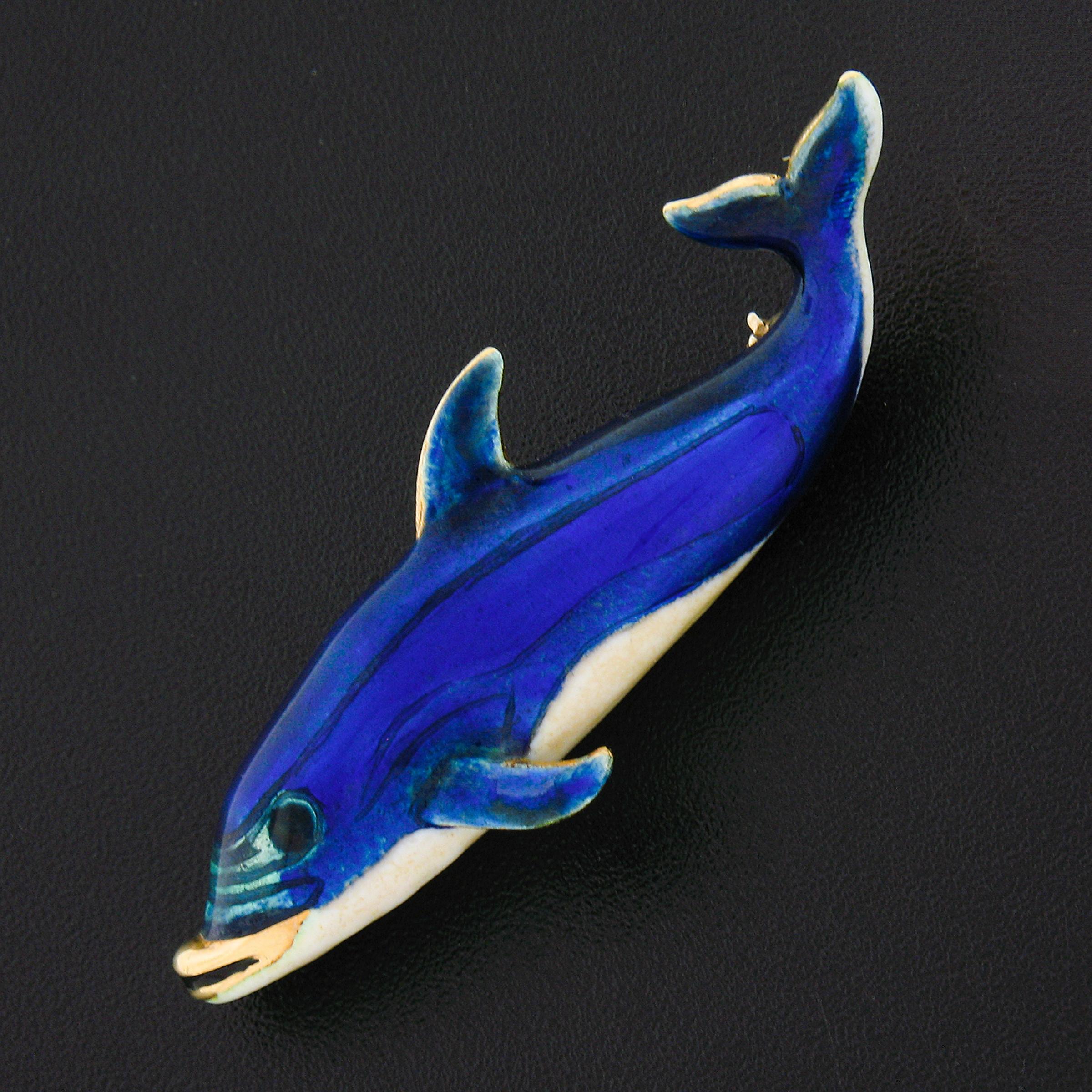 This adorable and very well made vintage pin/brooch is crafted in solid 14k yellow gold and features a gorgeous whale or dolphin design that's adorned with blue and white enamel work throughout. The back is equipped with a sturdy pin and rotating