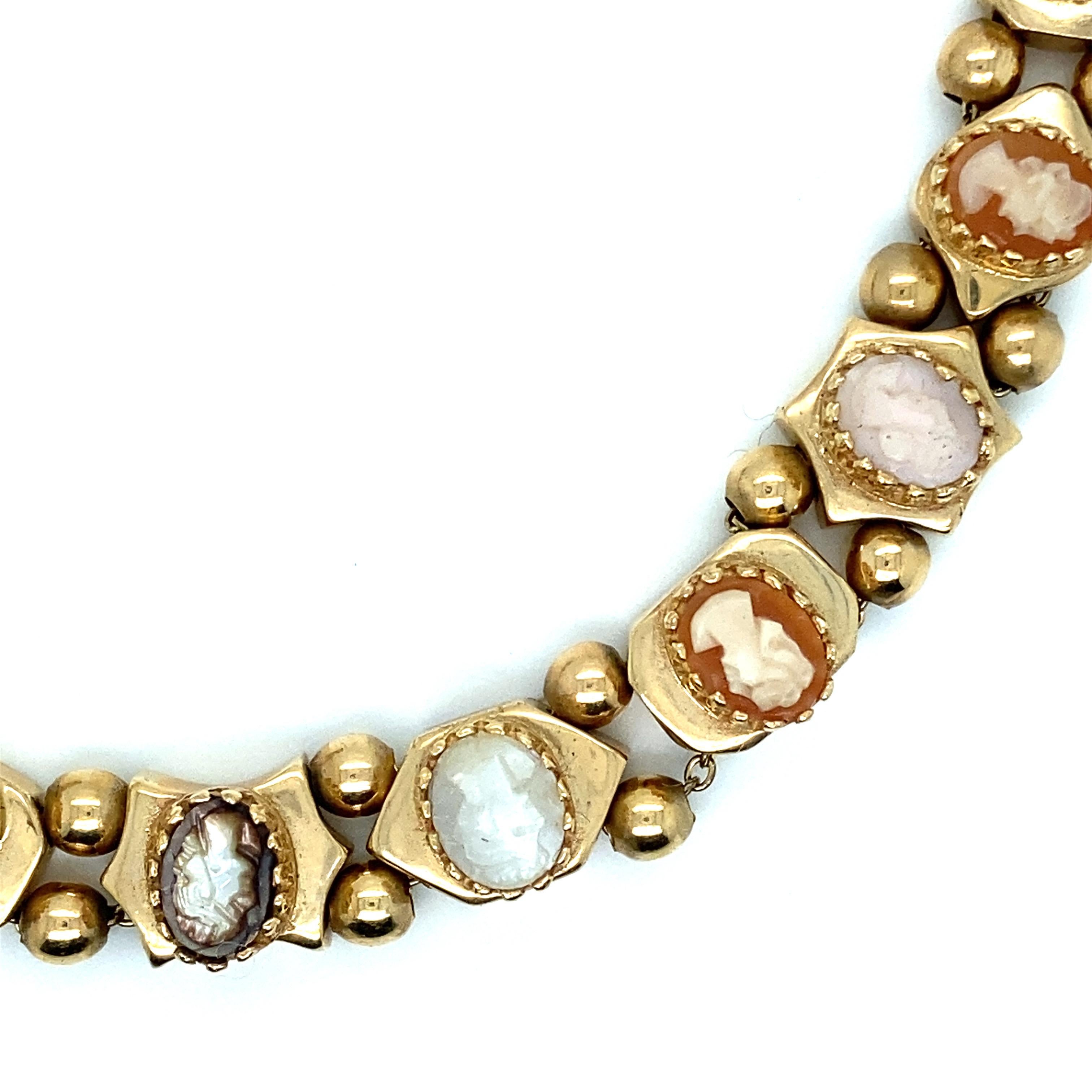 A stunning example of vintage artistry, this 14K yellow gold bracelet exudes Old World charm and elegance. Crafted meticulously with 12 exquisite cameo slides, each cameo is a miniature work of art carved from mixed color shells. The cameos depict