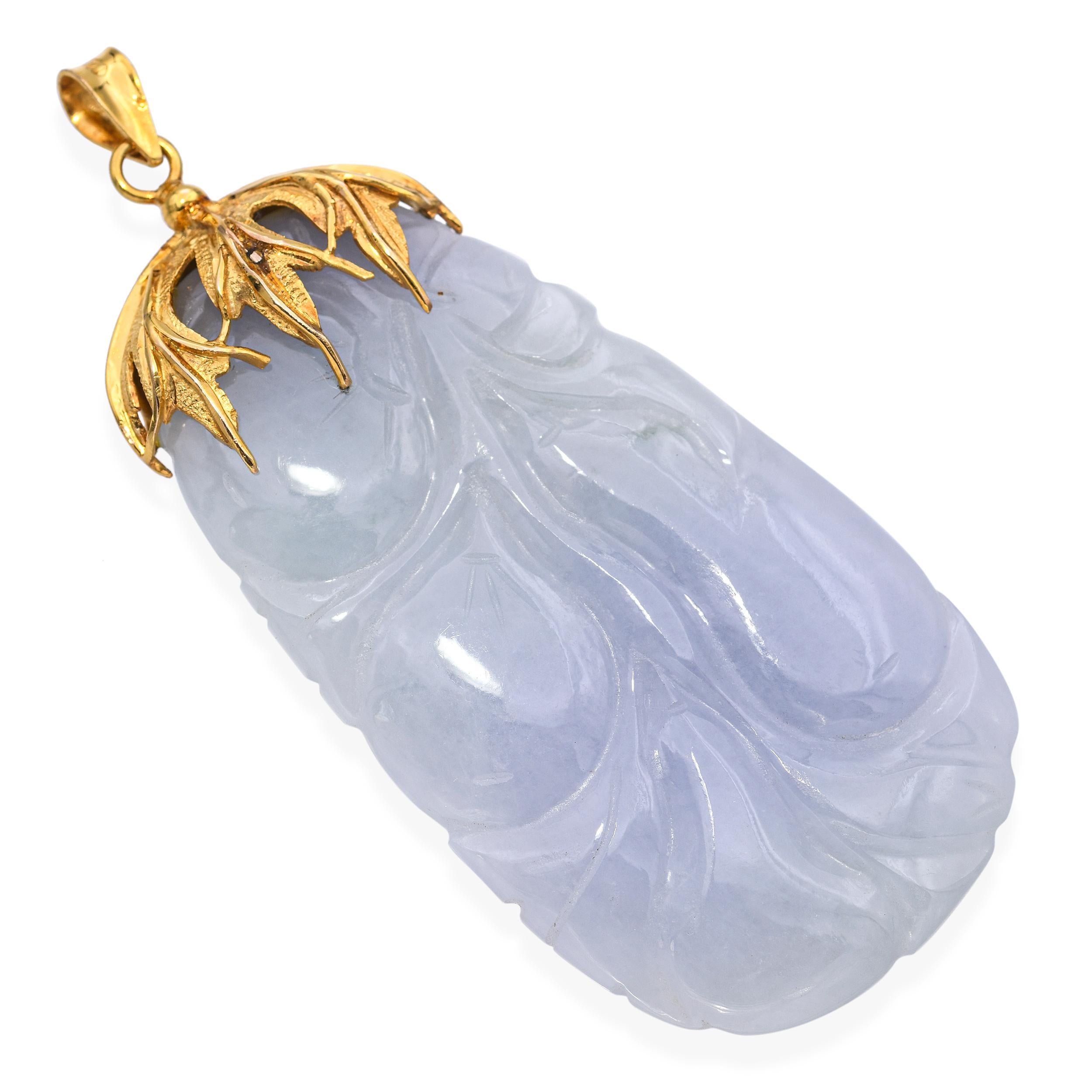 This elegant vintage pendant features a beautifully carved jade centerpiece, set in a warm 14k yellow gold frame. The jade displays natural tones and intricate detailing, reflecting expert craftsmanship and timeless design. Whether worn alone or