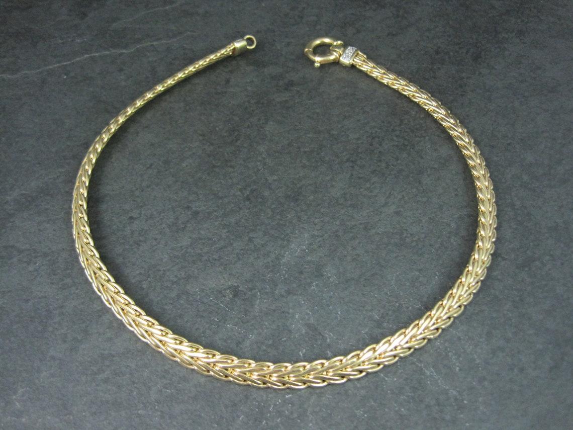This gorgeous necklace is solid 14k yellow gold with white gold accenting and natural diamonds.

Necklace Specifics:
14 Round Diamonds - 0.14ctw
Total weight - 40.6 grams
Chain - 8mm wide
16.5 inches long
Chunky nautical spring clasp.

Marks: K14,