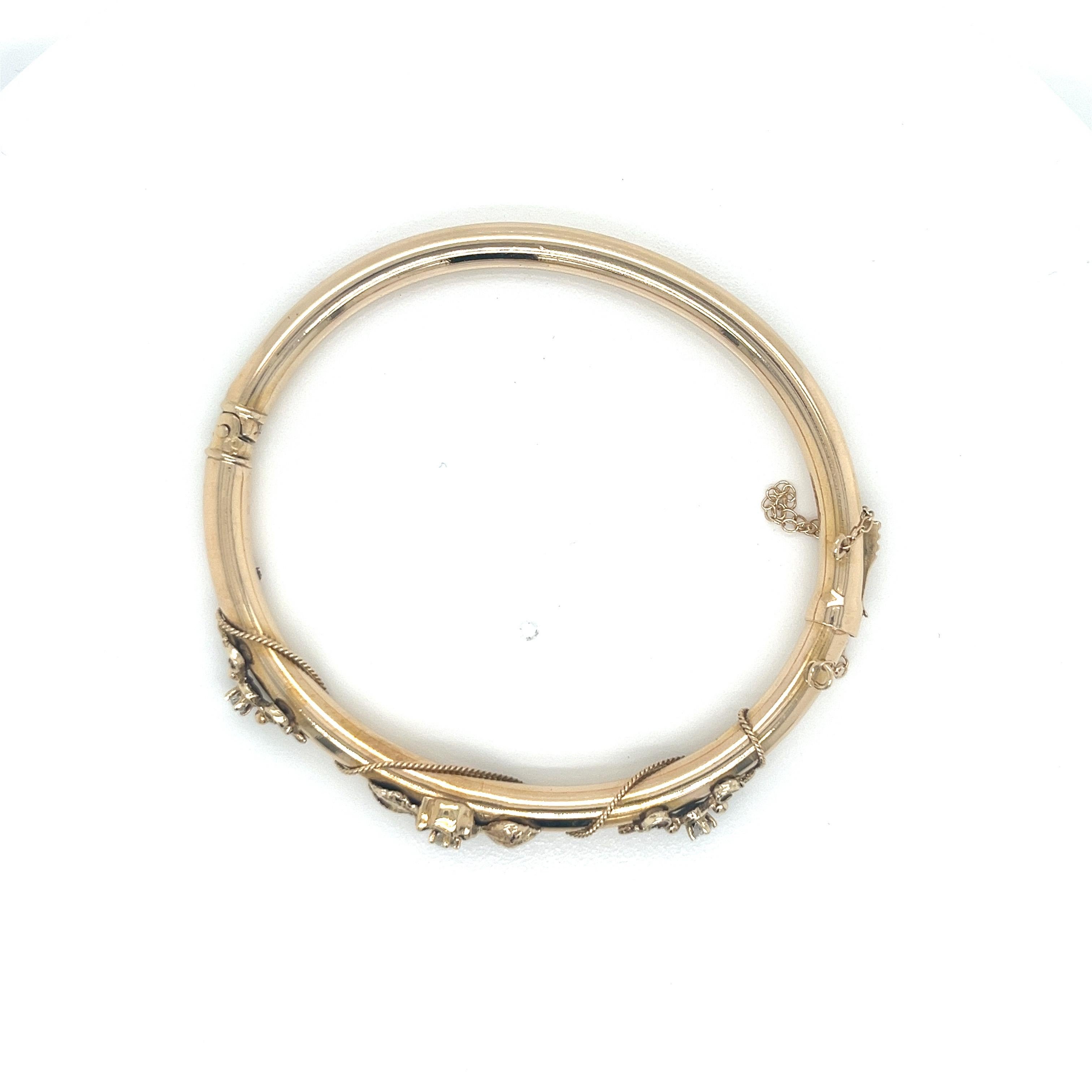 This stunning vintage bangle bracelet captures the timeless elegance of the 1940's era. Crafted from solid 14k yellow gold, this 4.7mm wide tubular bangle features a beautifully intricate design.

The top of the bangle is adorned with a decorative