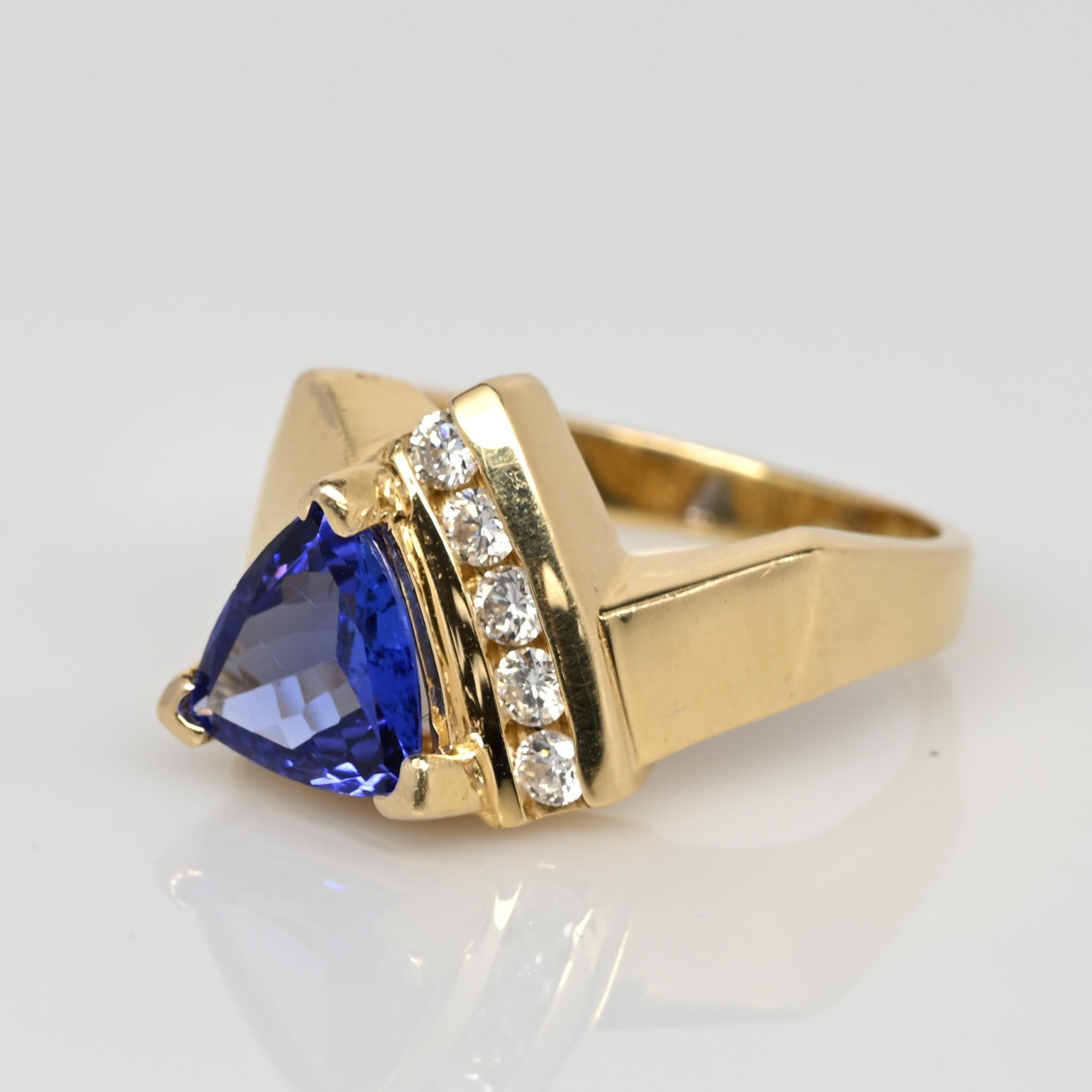 Introducing this truly one-of-a-kind creation meticulously crafted in 14K yellow gold. The geometric shanks add an artistic and contemporary touch to this stunning piece. A channel setting runs along the center, housing five dazzling round-cut