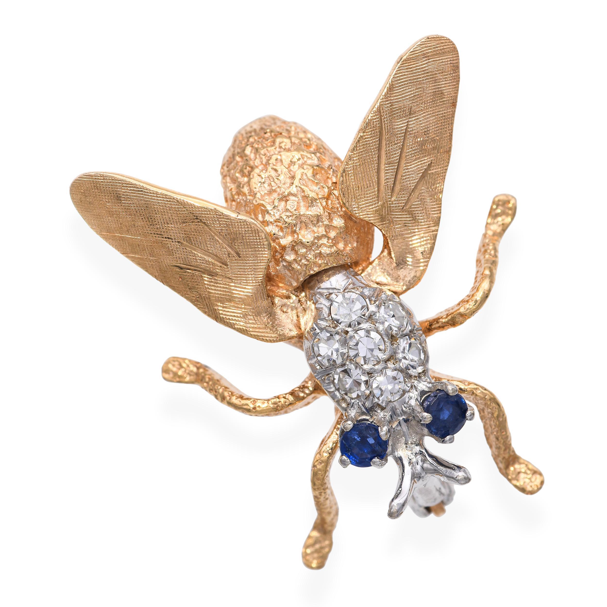 This charming vintage brooch is crafted in 14k yellow gold and designed in the whimsical form of a bumblebee. Its wings are accented with sparkling diamonds, while deep blue sapphires bring rich color to the body. The intricate detailing captures