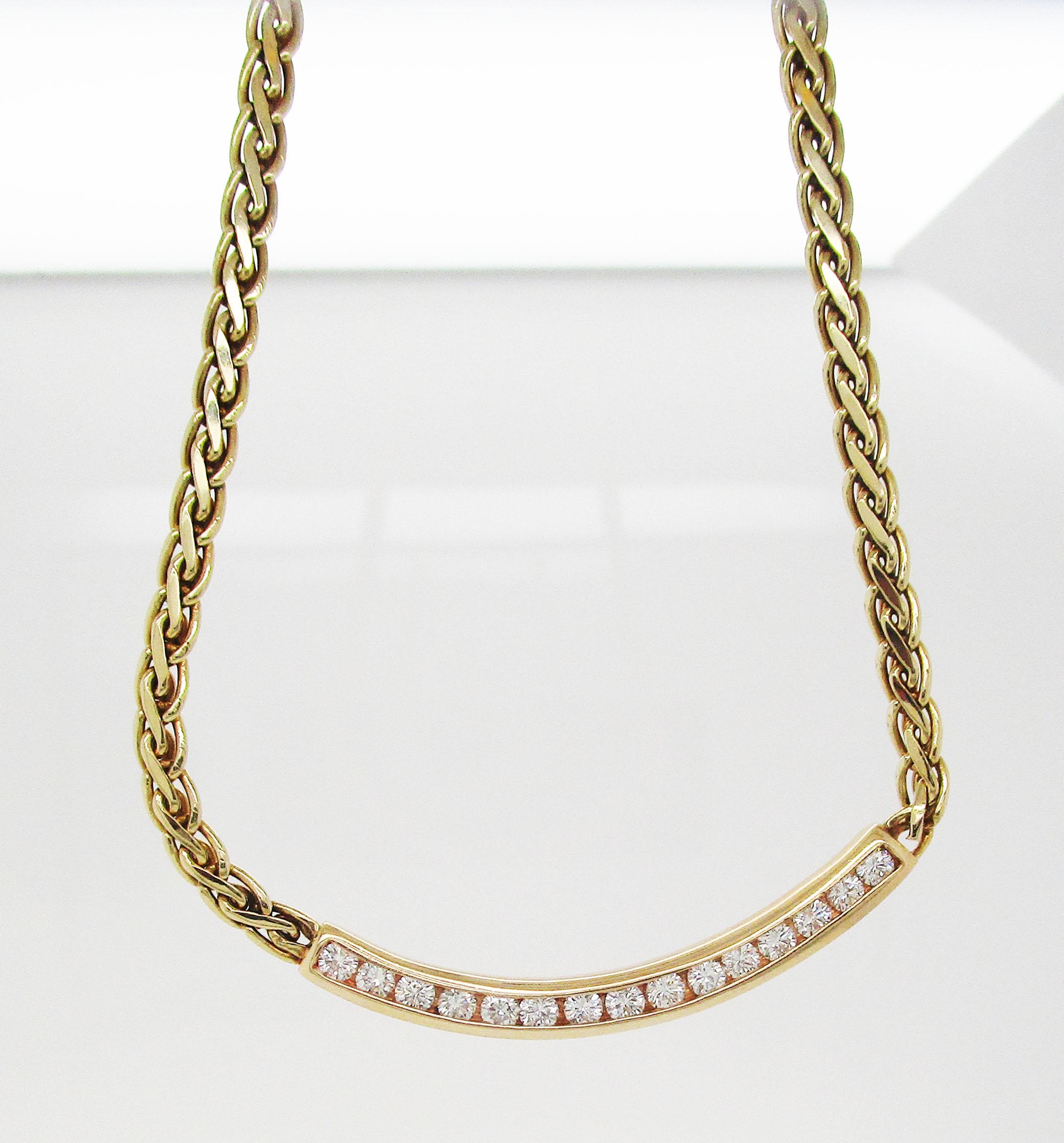 This is a stunning vintage necklace in 14k yellow gold featuring a fantastic curved center bar channel set with 15 gorgeous diamonds! The diamonds are absolutely brilliant and truly sparkle set against the yellow gold! This is an effortlessly