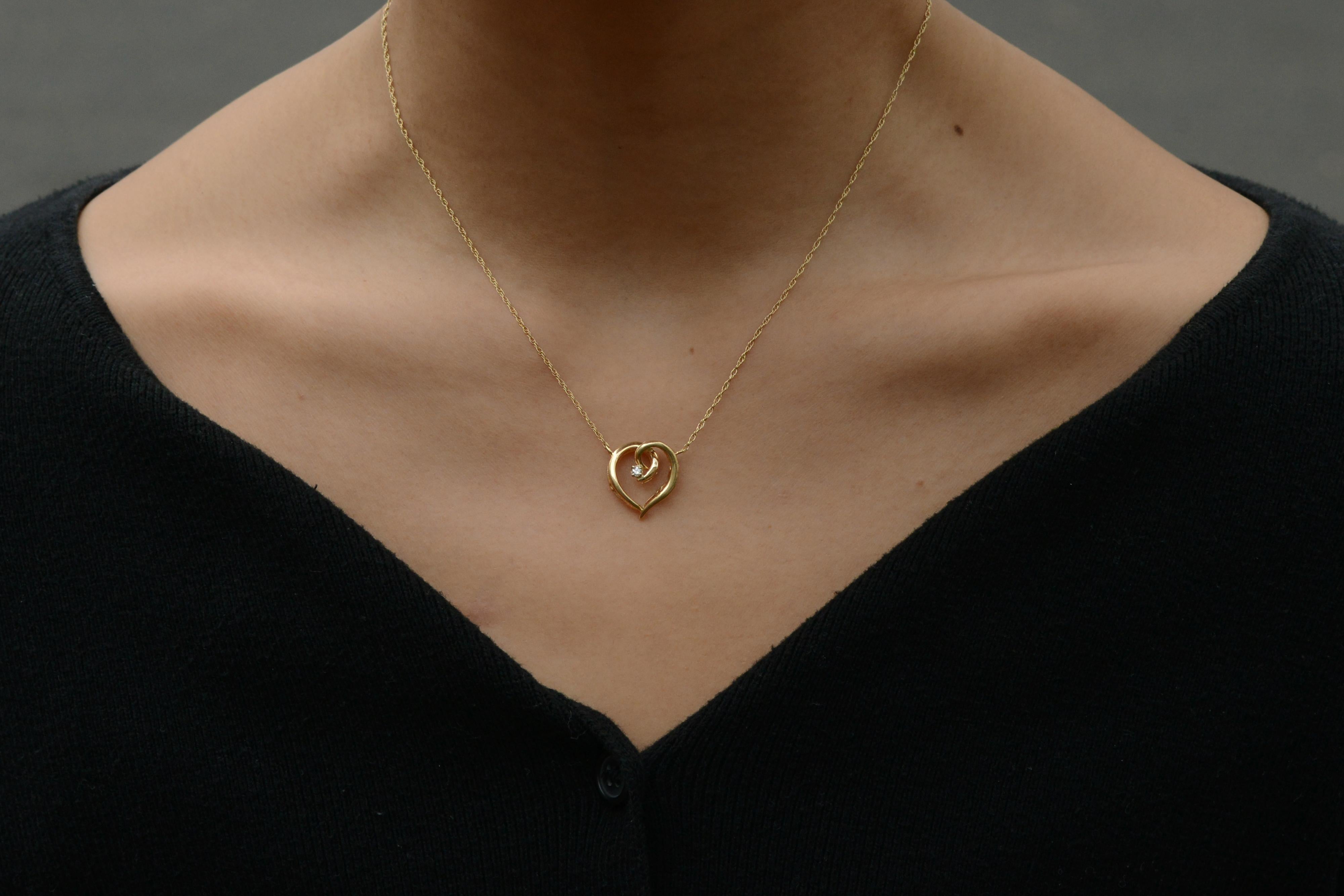 An affordable and sustainable option for the luxury-minded, this necklace is perfect for adding a touch of vintage elegance to any outfit. Featuring a dainty 14k gold link chain supporting an elegant, stylized heart featuring a single, sparkling