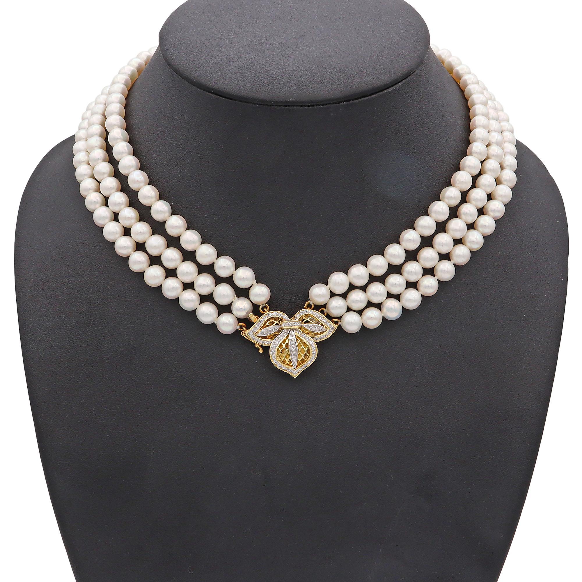 Experience the refined beauty of this exquisite beaded necklace. Crafted in 14K yellow gold, the necklace features lustrous white pearls, elegantly strung in three strands. The centerpiece is a gold clasp, intricately designed with leaf motifs,